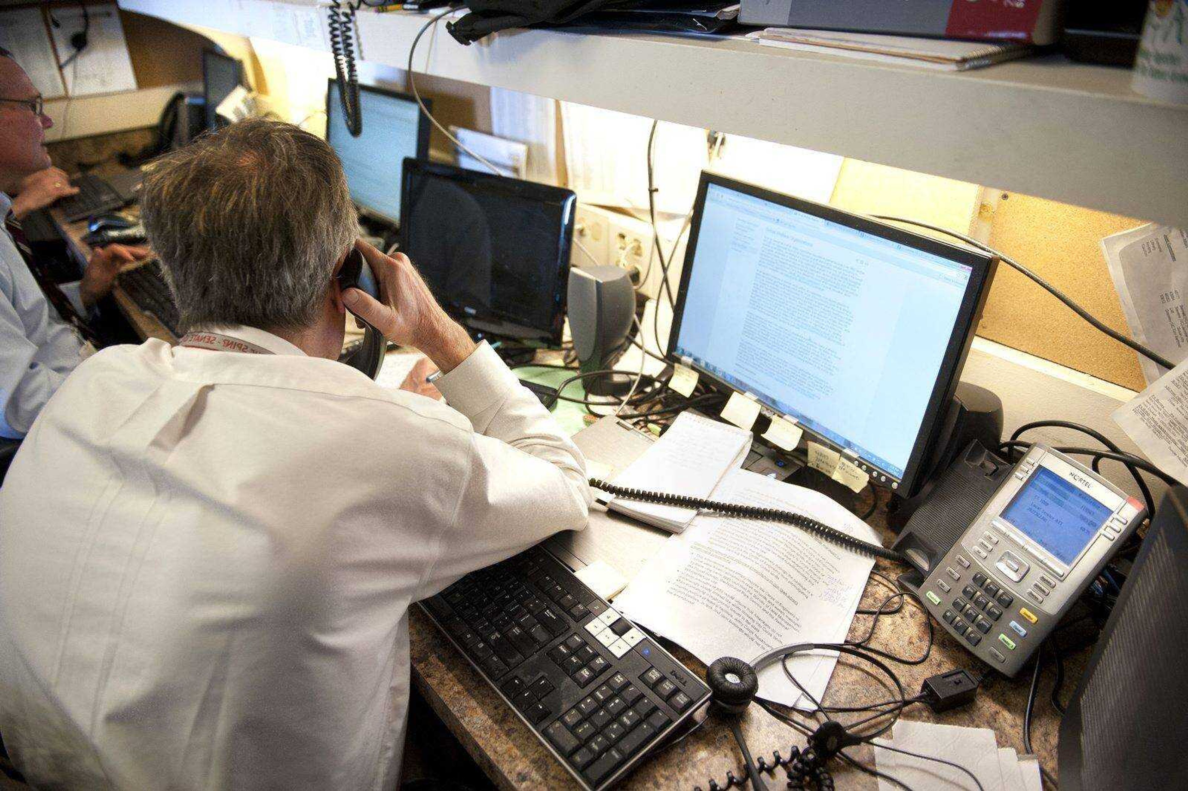 Cliff Owen ~ Associated Press (Associated Press reporters and editors work in their assigned space Tuesday in the House Press Gallery on Capitol Hill in Washington.)