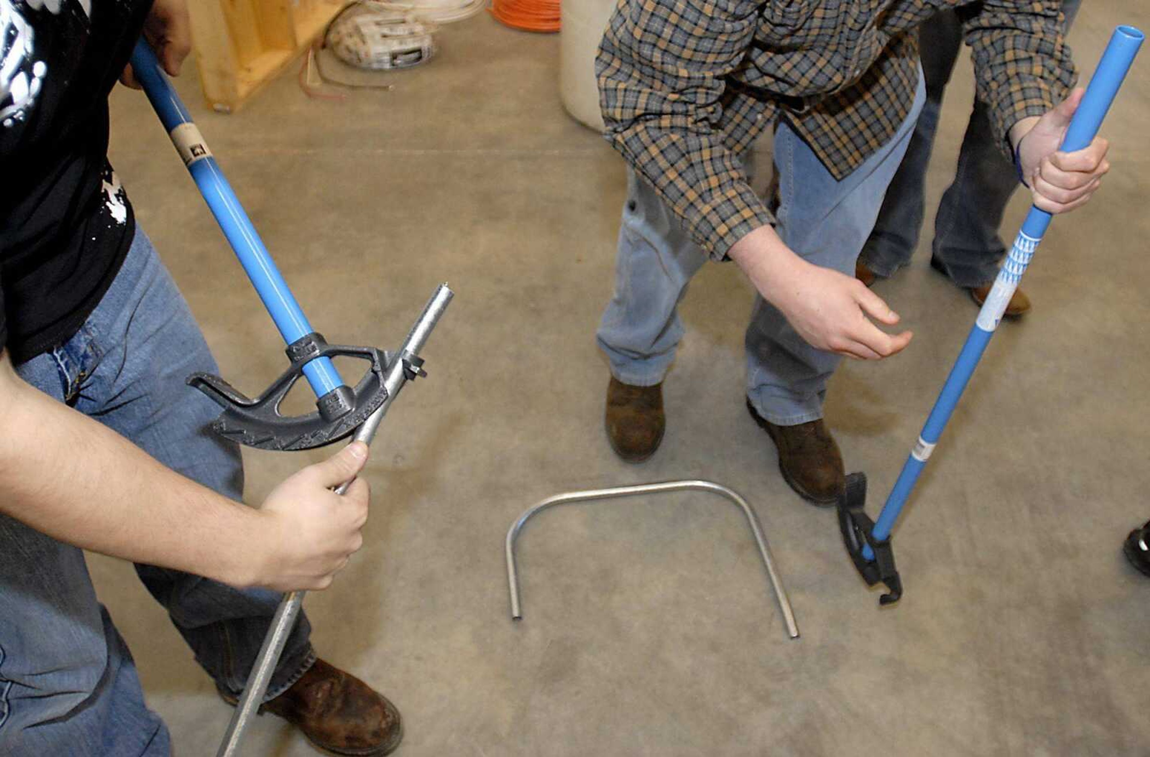 Maverick Boyer, left, and Terrence Lipps tried their hands at bending conduit in the electrical trades class Friday at the Cape Girar-deau Career and Technology Center.