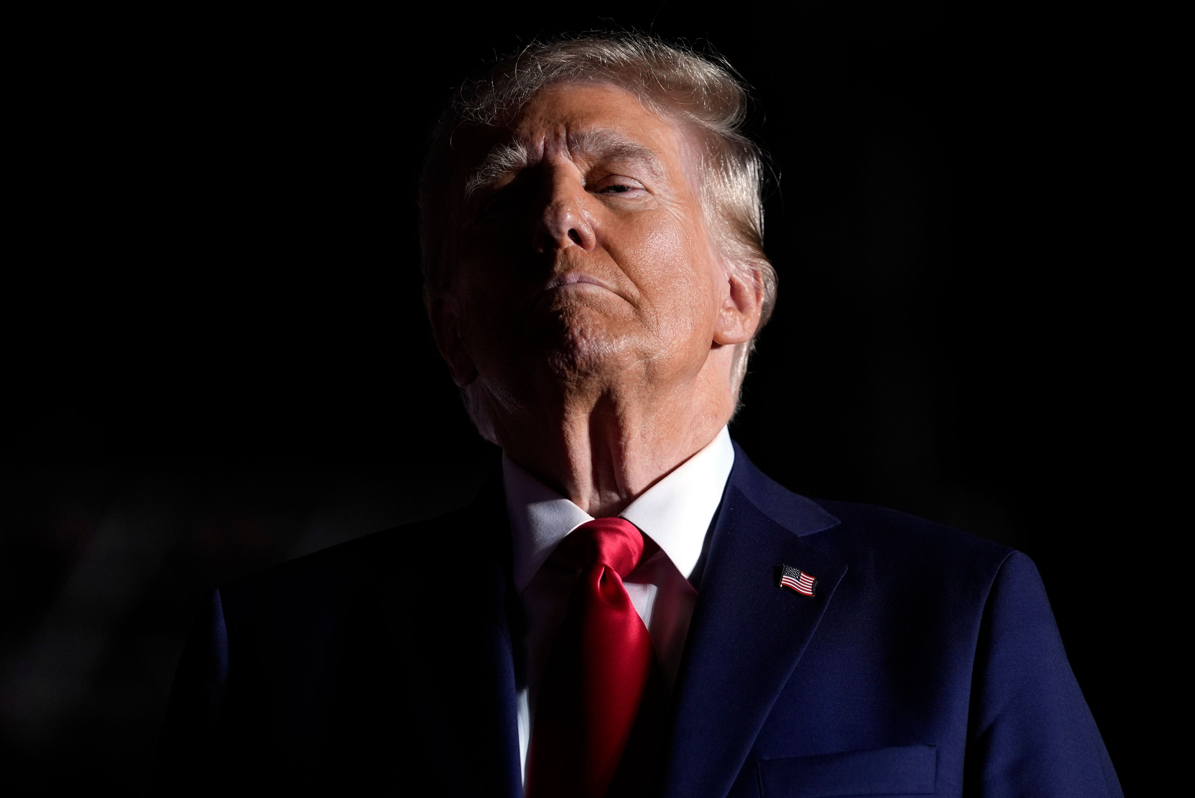 Republican presidential nominee former President Donald Trump listens to opera singer Christopher Macchio after speaking at a campaign rally at the Butler Farm Show, Saturday, Oct. 5, 2024, in Butler, Pa. (AP Photo/Evan Vucci)