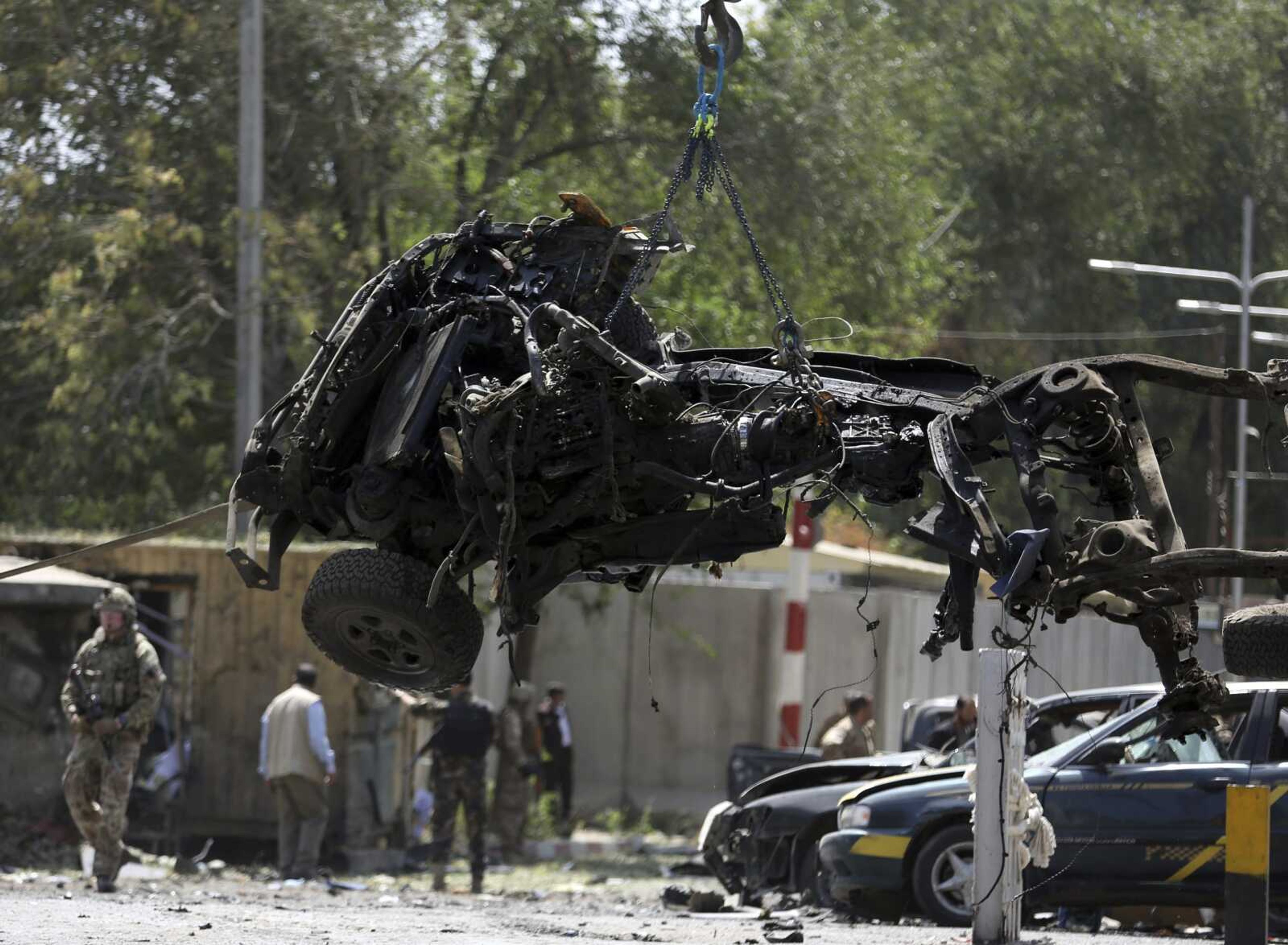 File- in this Thursday, Sept. 5, 2019. Photo, Resolute Support (RS) forces remove a destroyed vehicle after a car bomb explosion in Kabul, Afghanistan. An American service member was killed in action on Monday in Afghanistan the U.S. military said in a statement without providing more details. (AP Photo/Rahmat Gul, file)