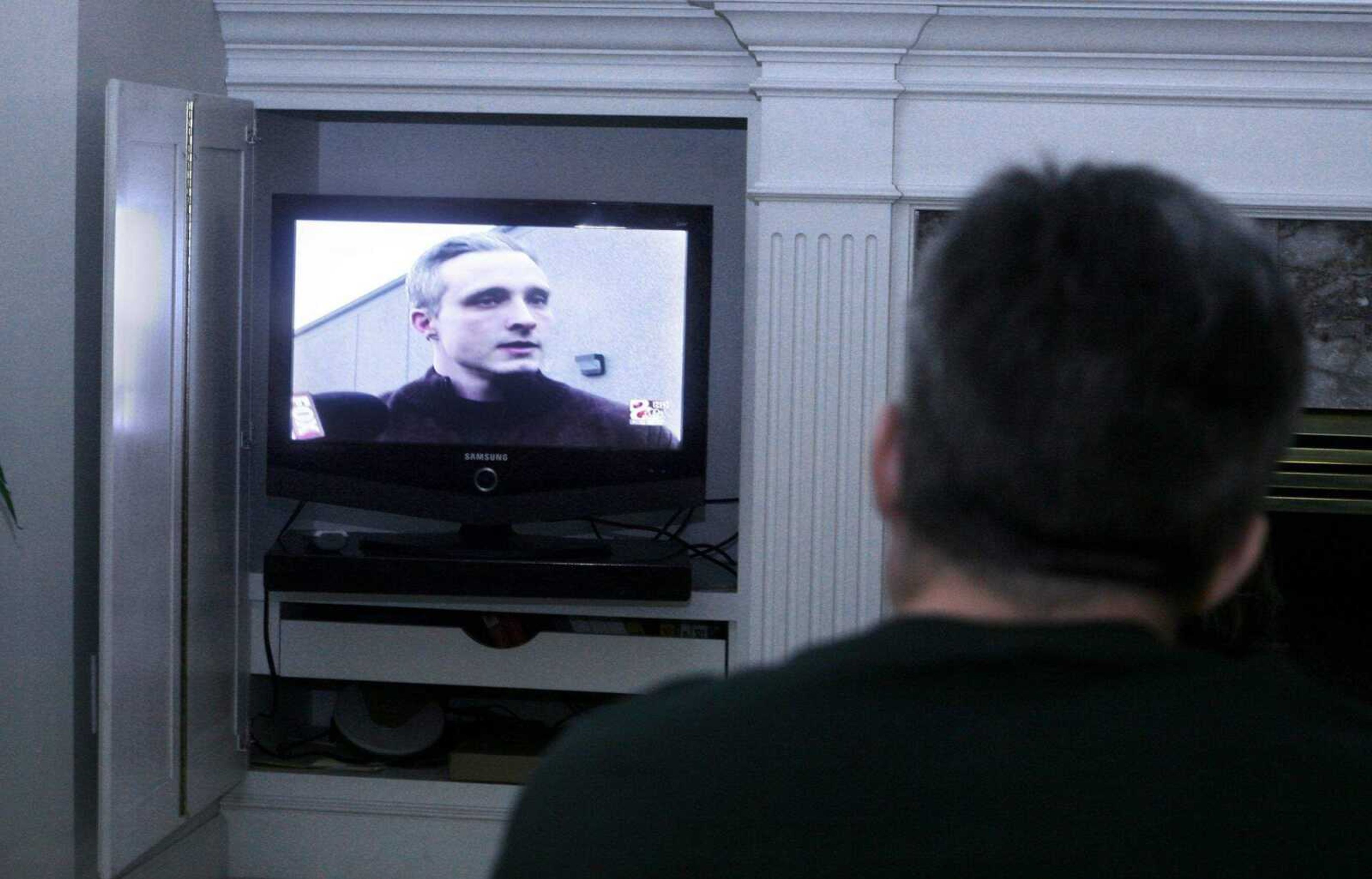 ELIZABETH DODD ~ edodd@semissourian.com
Kezer watches himself on different news outlets on the 10:00 news at a friend's home in Columbia.