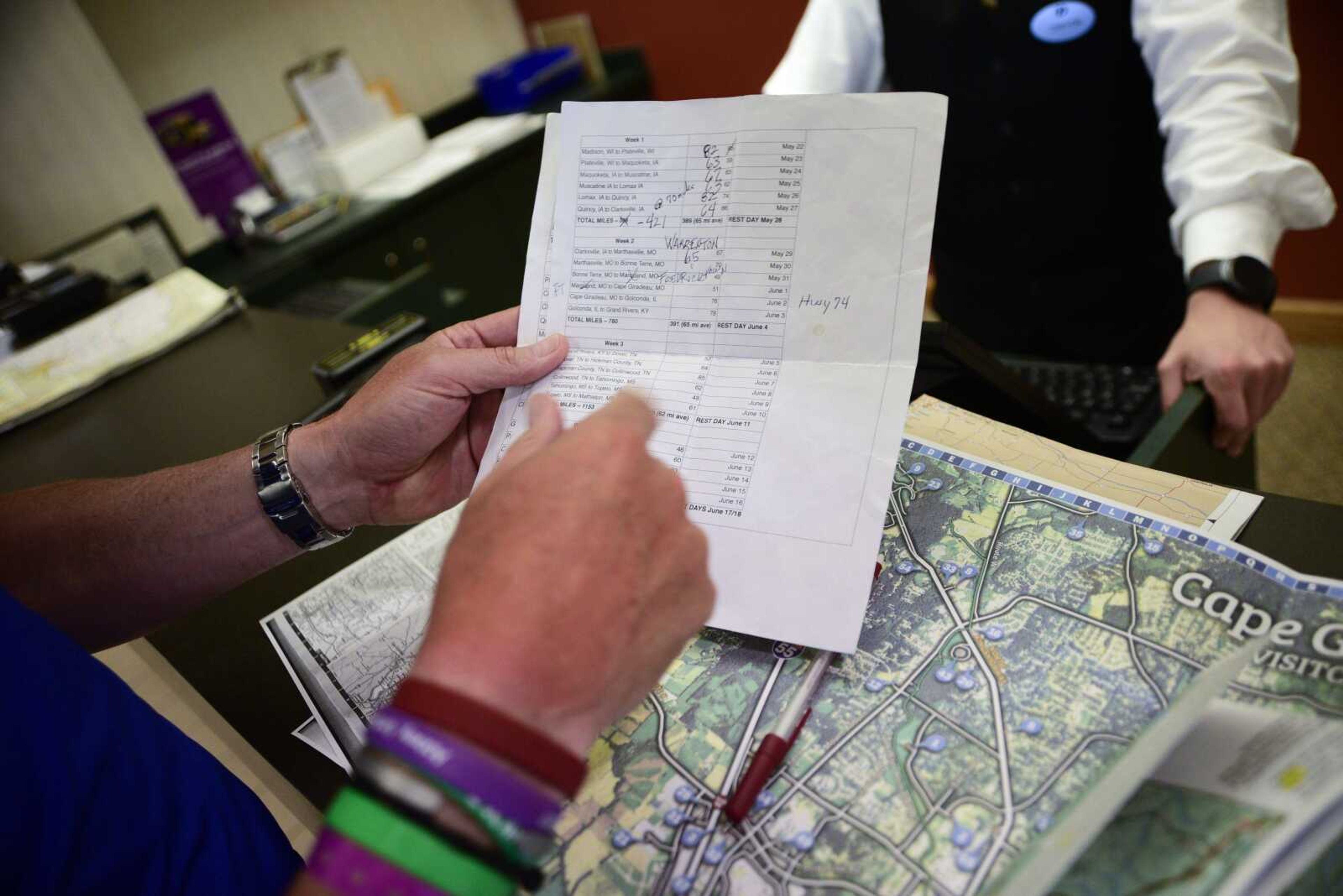 Bill Conner looks at maps in the hotel lobby of the Pear Tree Inn on his journey from  Wisconsin to Florida for organ-donor awareness.