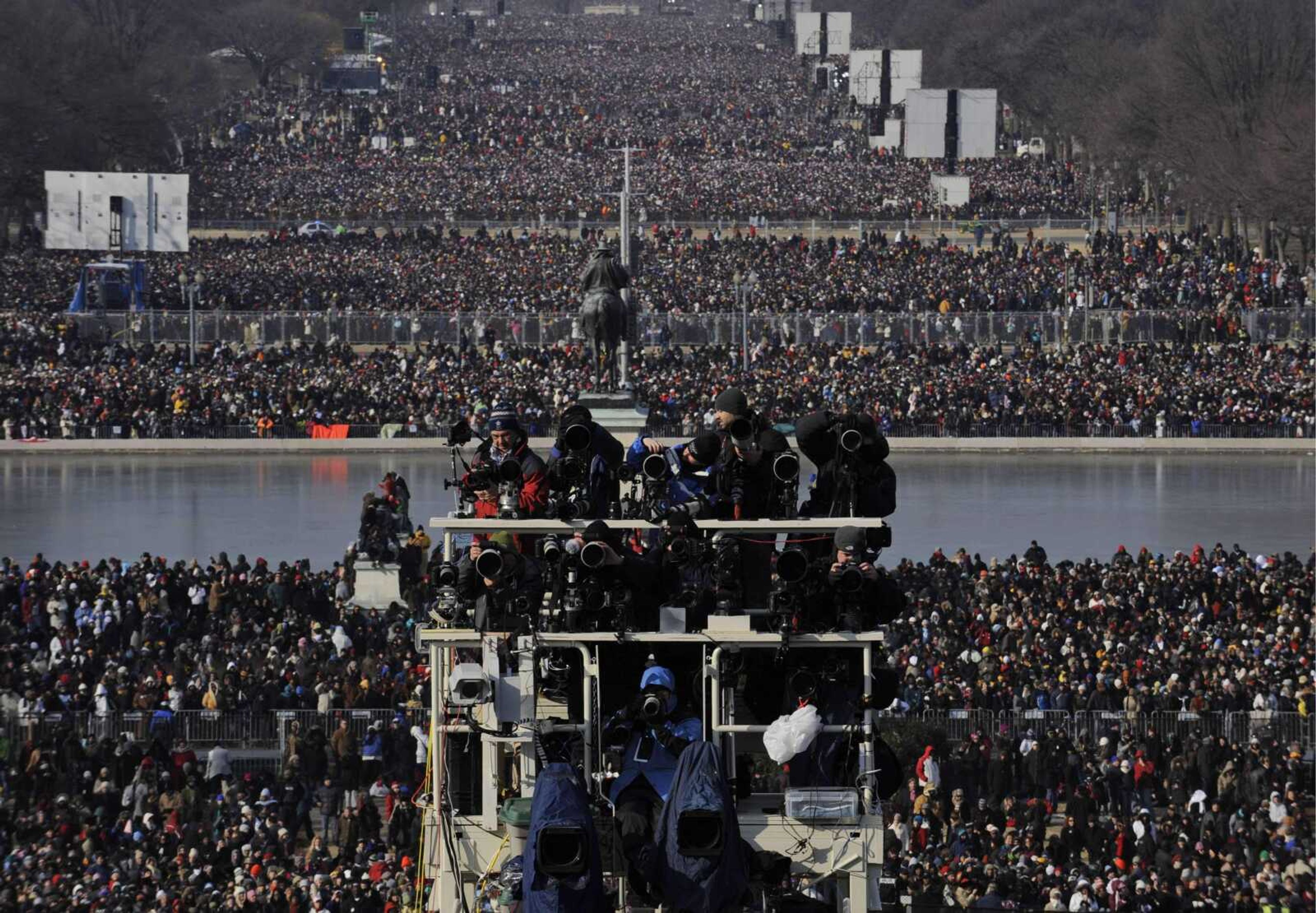 Photographers crowd a camera stand as people fill the National Mall before the inauguration of Barack Obama and Joe Biden at the U.S. Capitol in Washington, Tuesday, Jan. 20, 2009. (AP Photo/Susan Walsh)