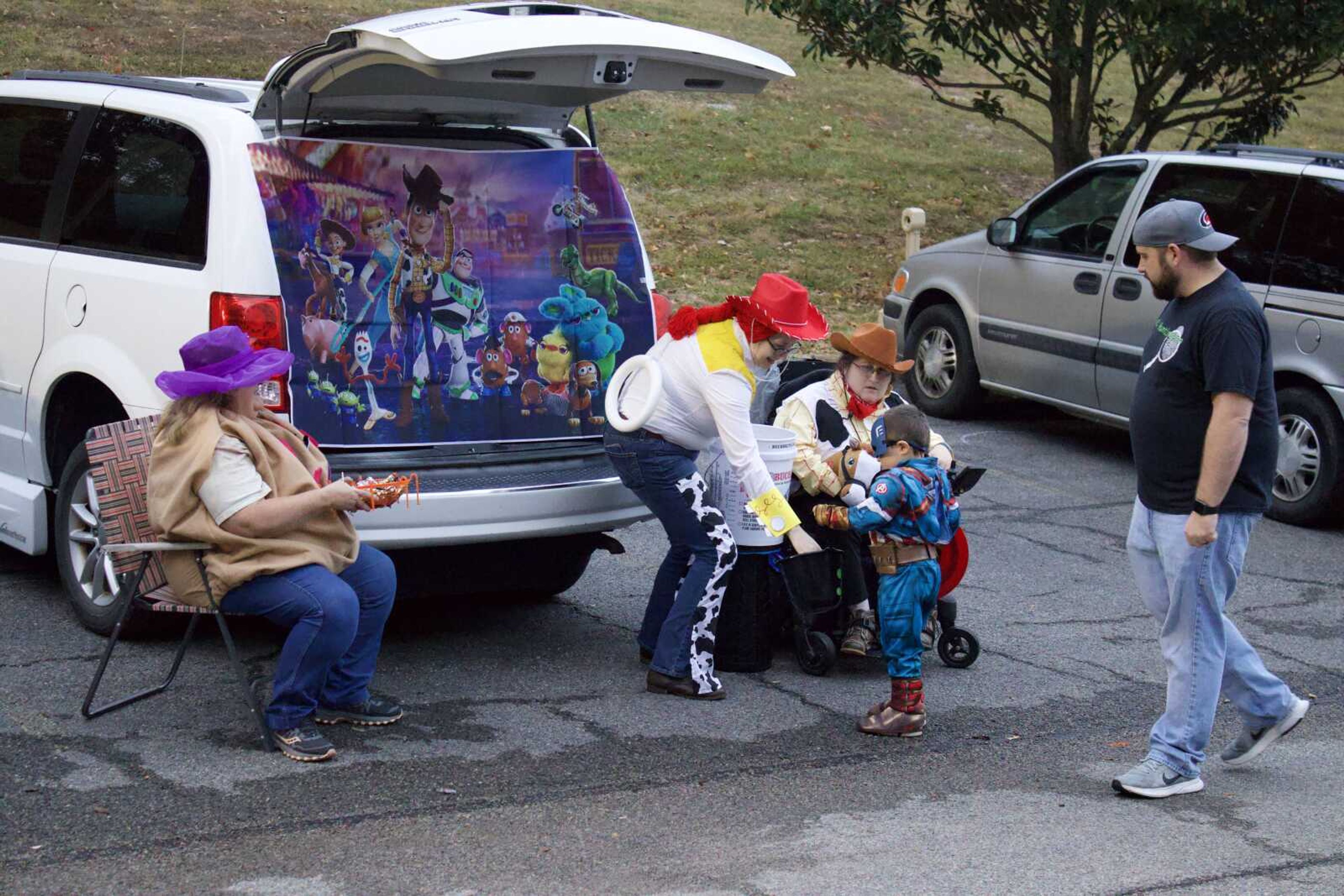 Margie, Rachel, and Becki Nation hand out candy 
outside their van on Monday, Oct. 31 at Lynwood Baptist Church as part of the church's 'Trunk or Treat' event. They dressed as characters from 'Toy Story' such as 
Woody and Mrs. Potatohead. (Photo by Jeffery Long)