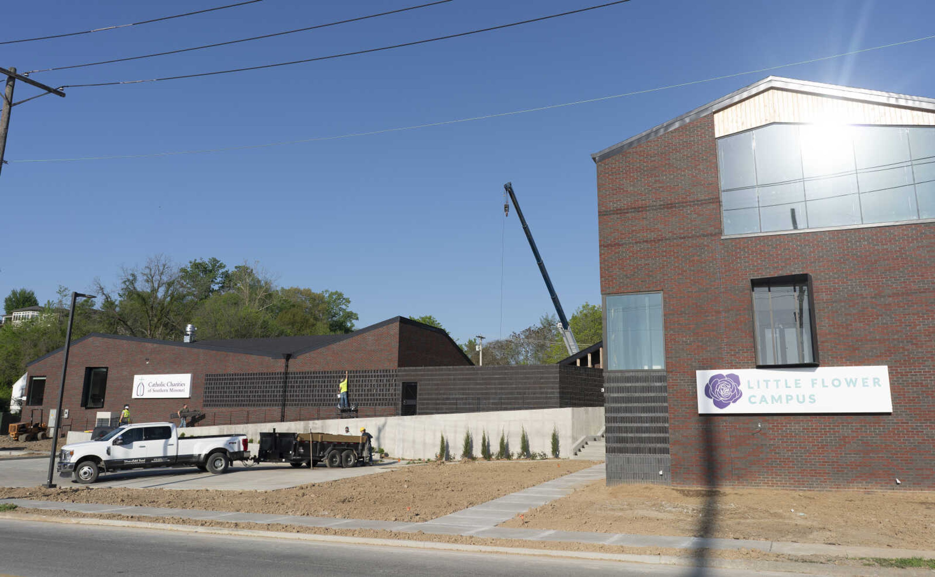 Crews work on landscaping and put the finishing touches on the new Catholic Charities of Southeast Missouri LifeHouse. (Photo by Aaron Eisenhauer)