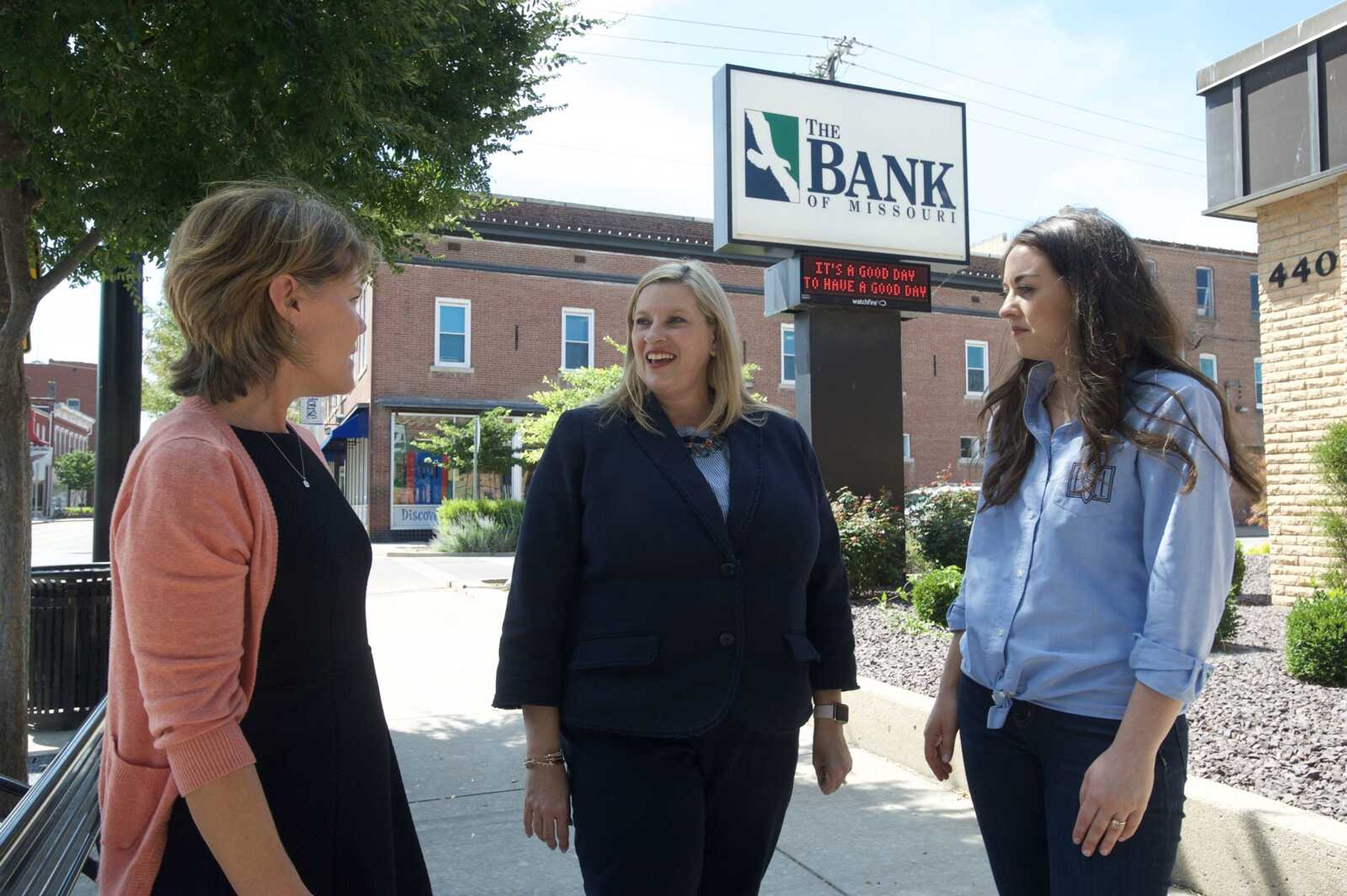 Dawn Dauer, chief banking officer at The Bank of Missouri and member of Old Town Cape, talks with Marla Mills, executive director of Old Town Cape, and Emilie Stephens, president of Old Town Cape, in downtown Cape Girardeau. 