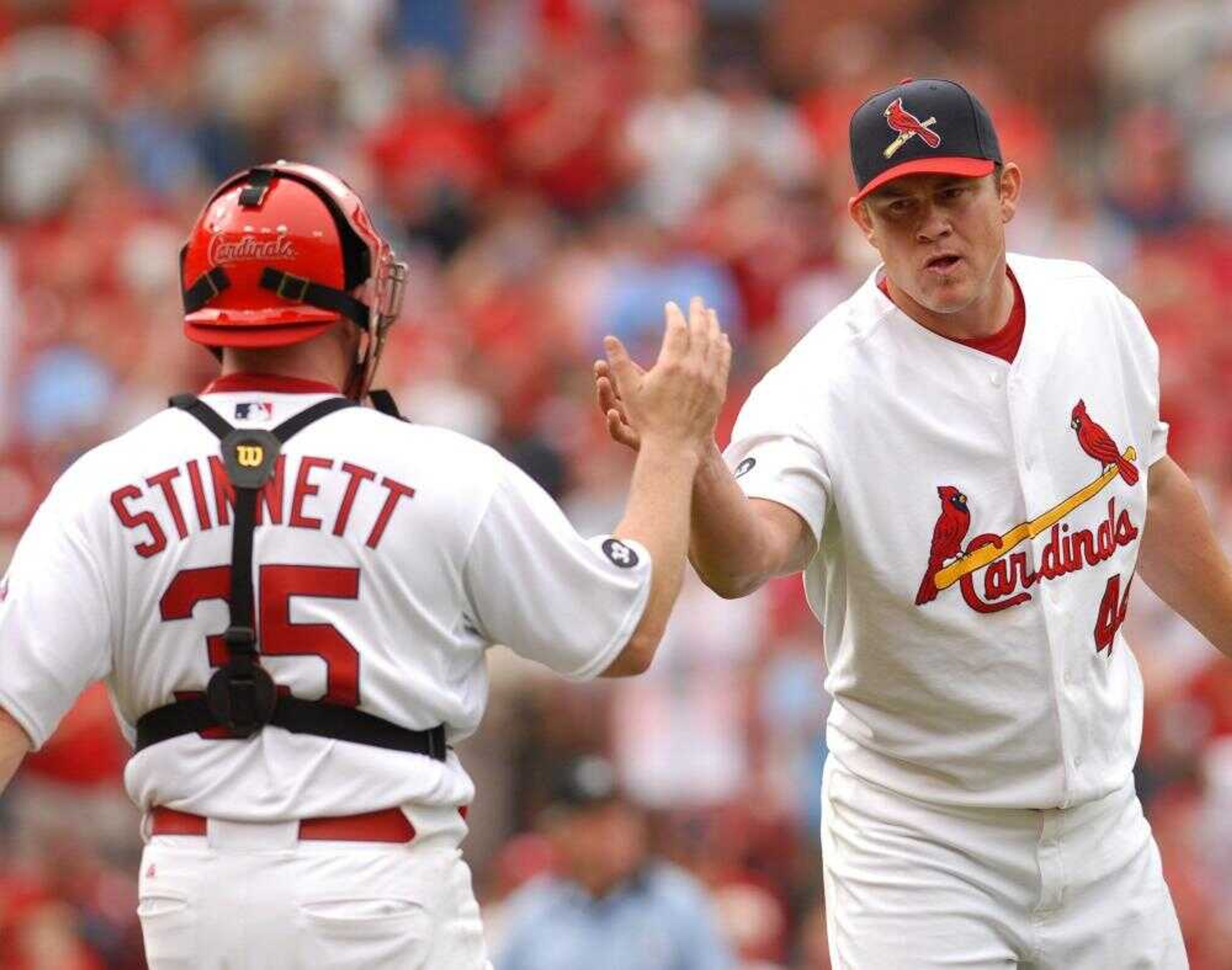 St. Louis catcher Kelly Stinnett congratulated closer Jason Isringhausen after the Cardinals beat the Angels on Sunday in St. Louis. (Bill Boyce ~ Associated Press)