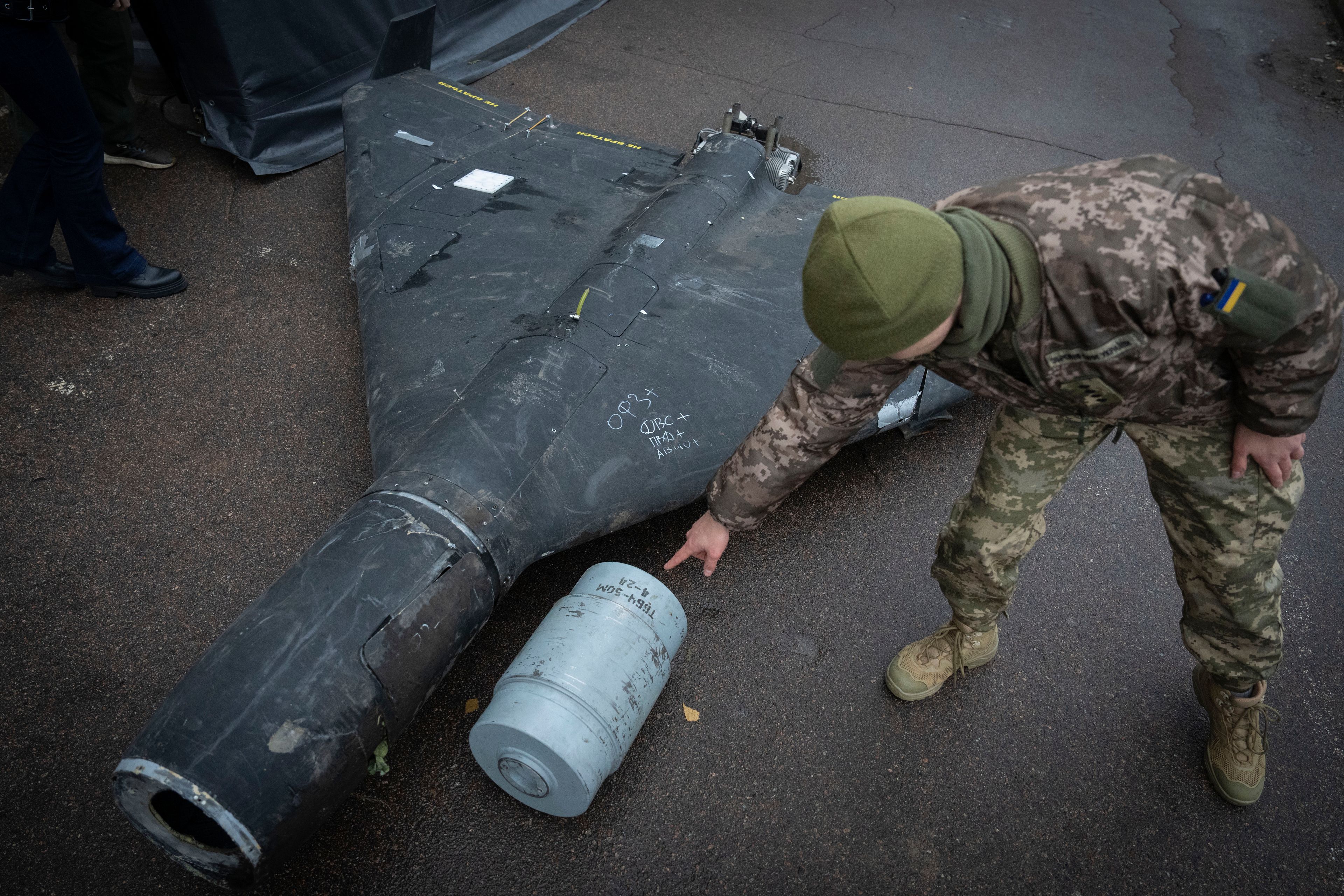 A Ukrainian officer shows a thermobaric charge of a downed Shahed drone launched by Russia in a research laboratory in an undisclosed location in Ukraine Thursday, Nov. 14, 2024. (AP Photo/Efrem Lukatsky)