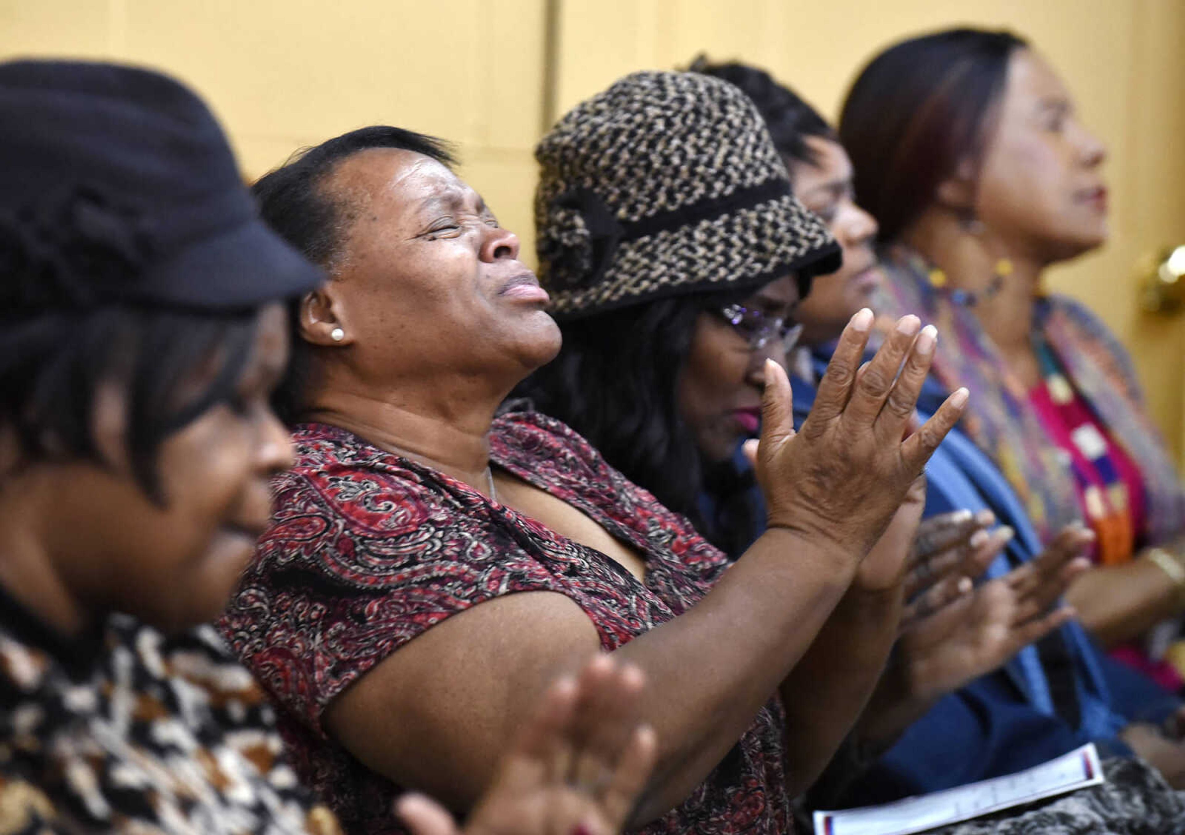 Jennett McCaster prays during the opening prayer of "And Justice For All's" Martin Luther King Jr. Day program on Monday, Jan. 16, 2017, at New Life New Beginning World Outreach Center in Sikeston, Missouri.