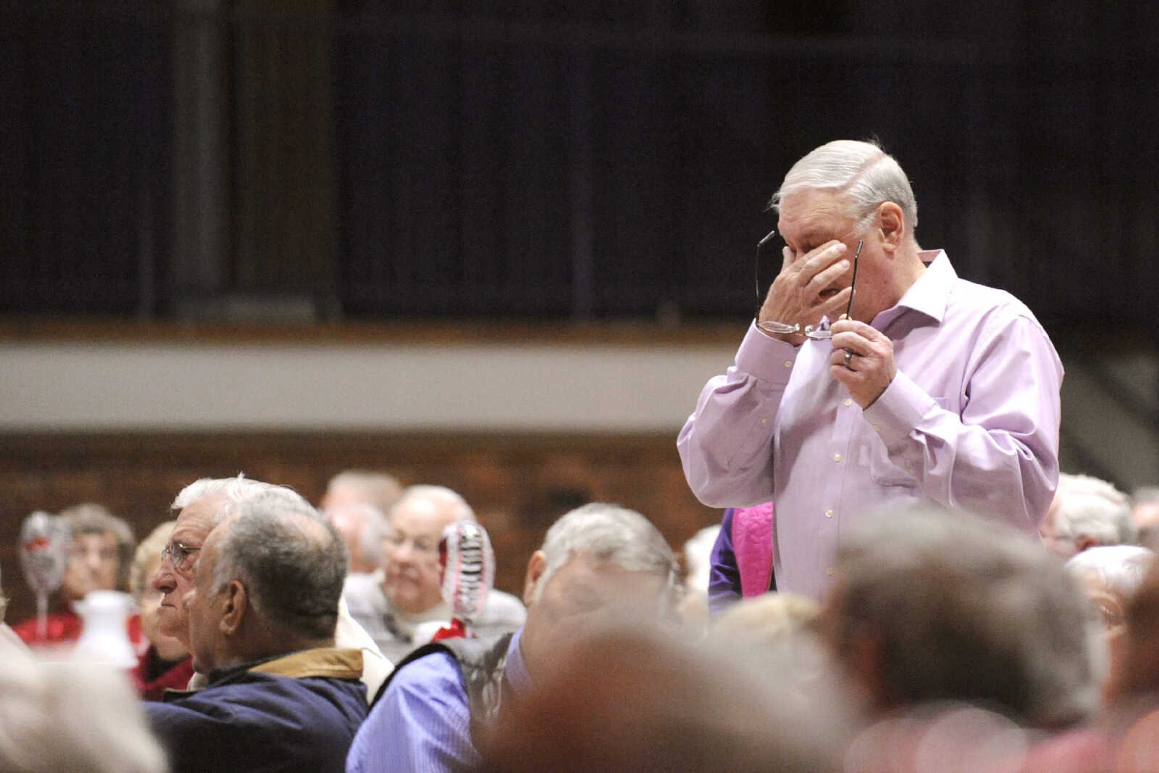 GLENN LANDBERG ~ glandberg@semissourian.com

Tom Wright takes a moment as Mike Dumey sings "God Bless the USA" during the Valentine's Party sponsored by Schnucks Supermarket for couples who have been married for 50 or more years at the Arena Building Friday, Feb. 13, 2015.