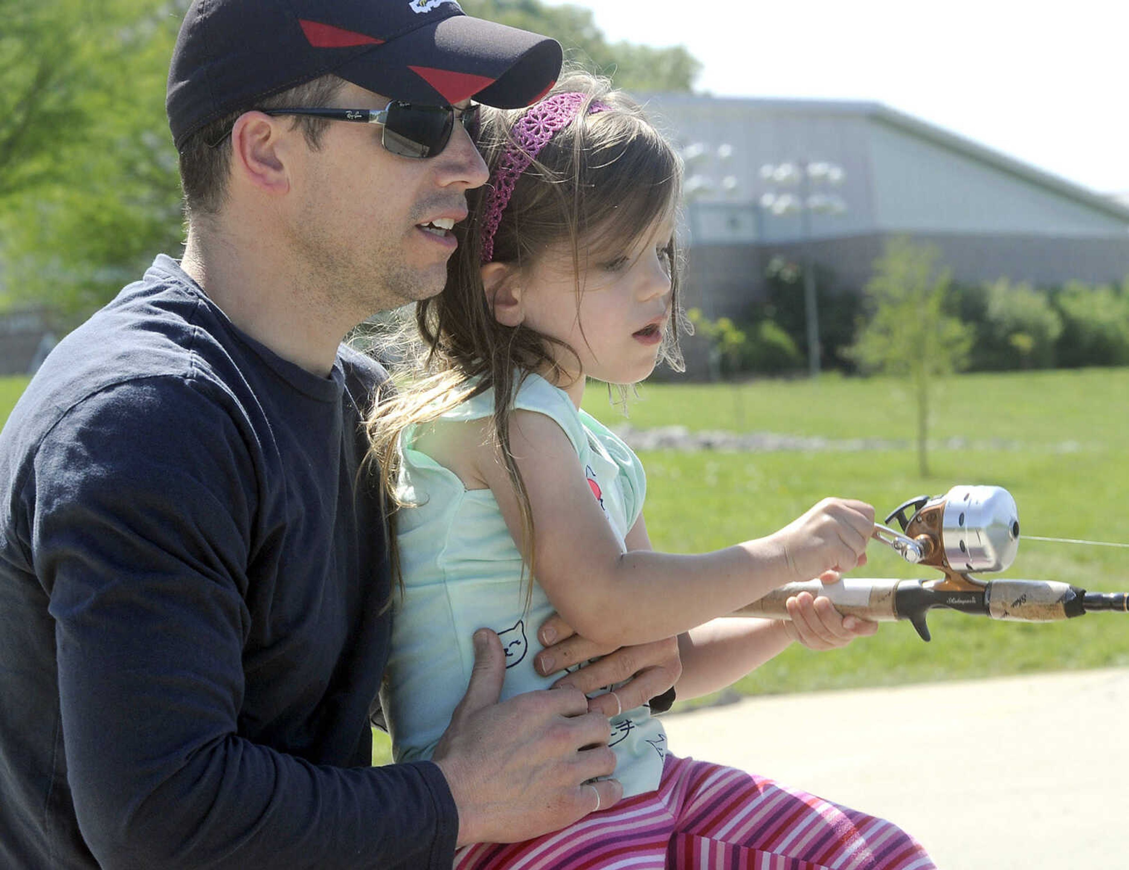 FRED LYNCH ~ flynch@semissourian.com
Shawn Downs and his daughter, Emmie, try some fishing at the pond during the Cape Girardeau County Conservation Nature Center's 10th anniversary Saturday, May 2, 2015.