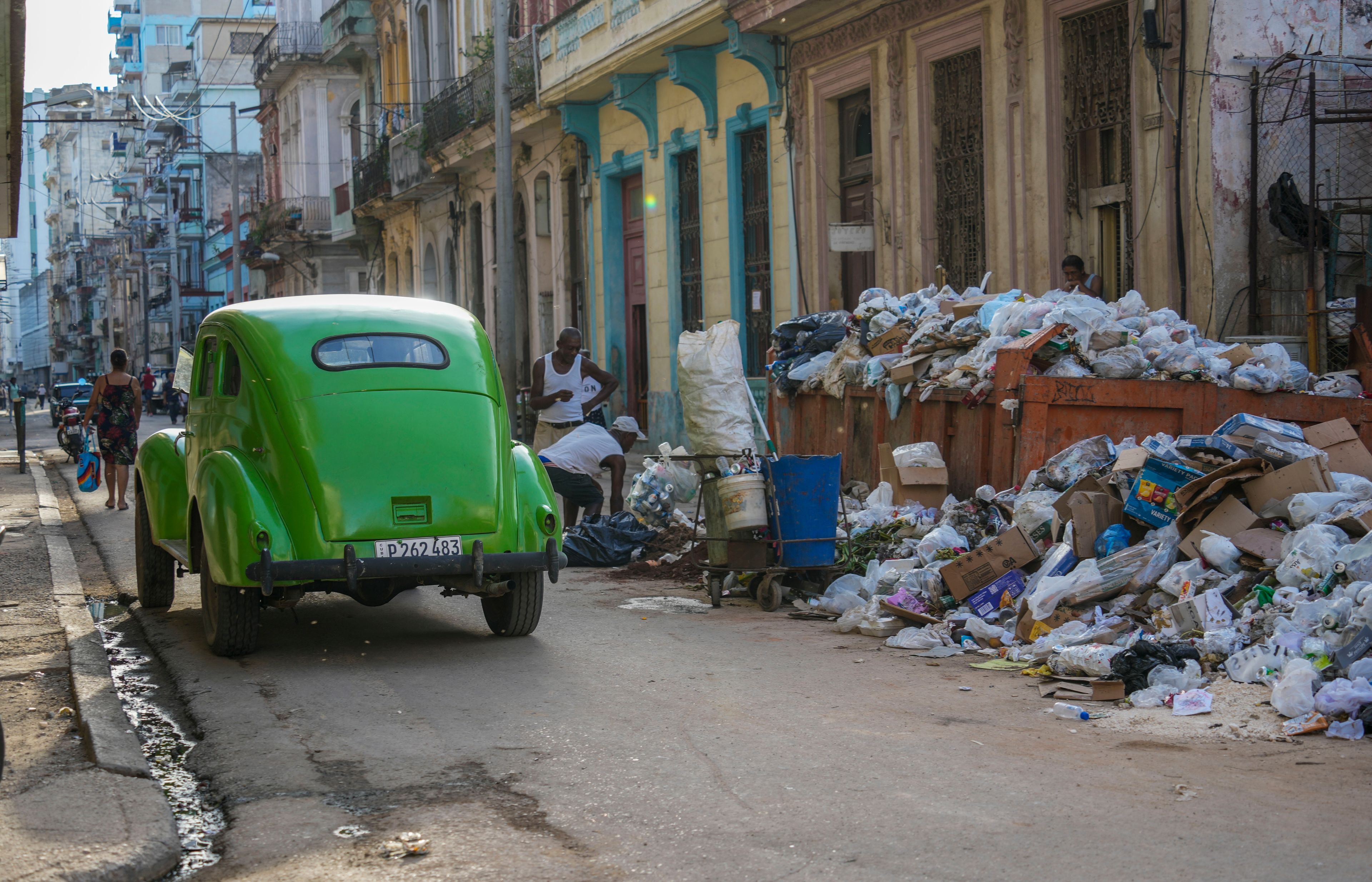 FILE- A classic American car drives past garbage in Havana, Cuba, Sept. 24, 2024. (AP Photo/Ramon Espinosa, File)