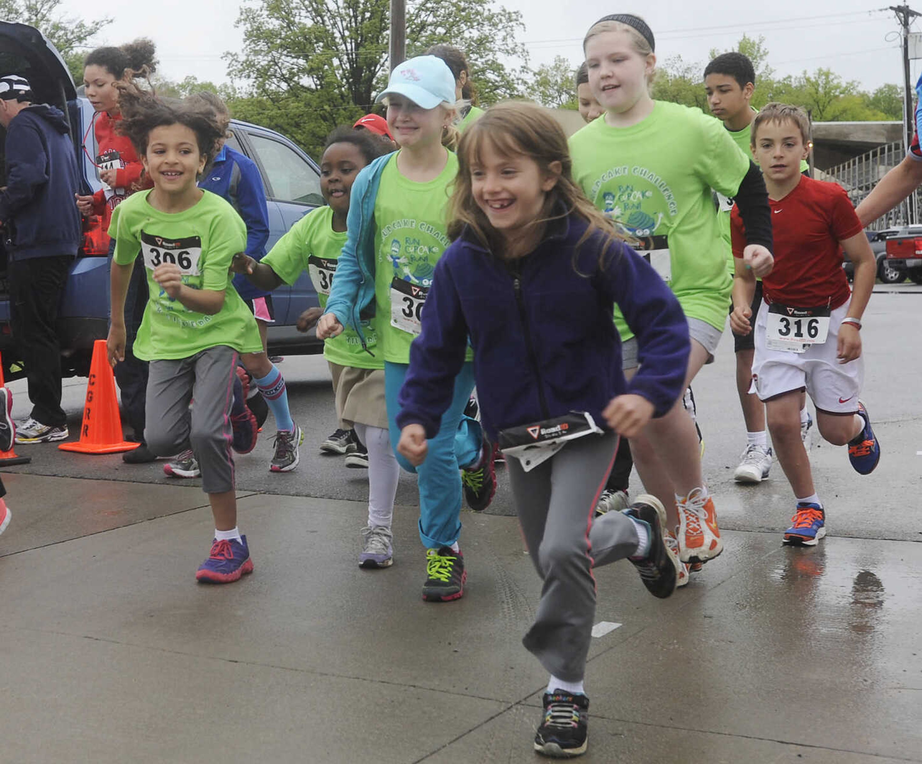 Kids take off at the start of the 1-mile race during the 2013 Cupcake Challenge Sunday, May 5, at Arena Park in Cape Girardeau.