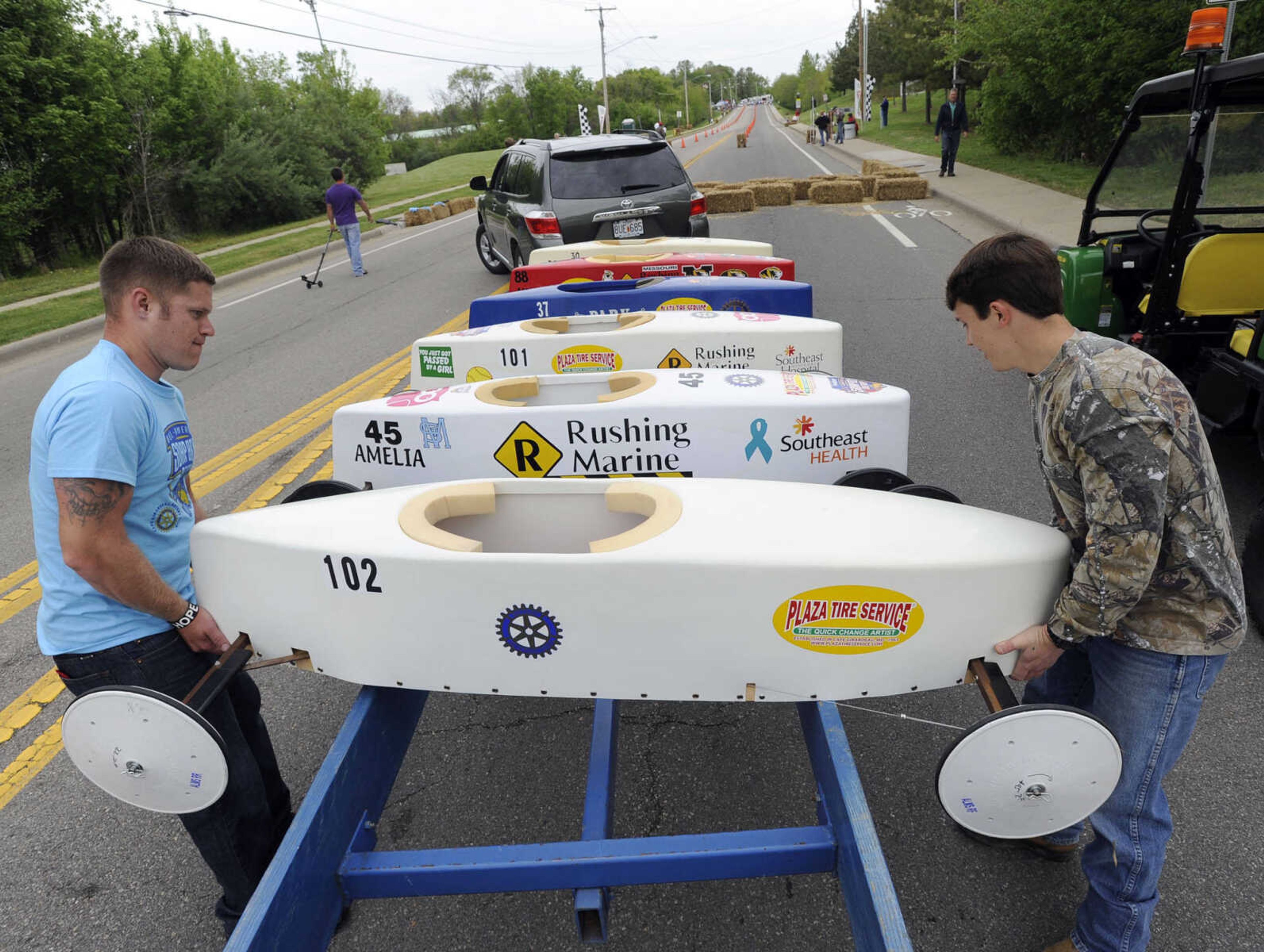 Joshua Dowler, left, and J.J. Rickis with Teen Challenge place race cars on a trailer during the Soap Box Derby sponsored by the Cape Girardeau Rotary Club on Saturday, May 3, 2014 in Cape Girardeau.