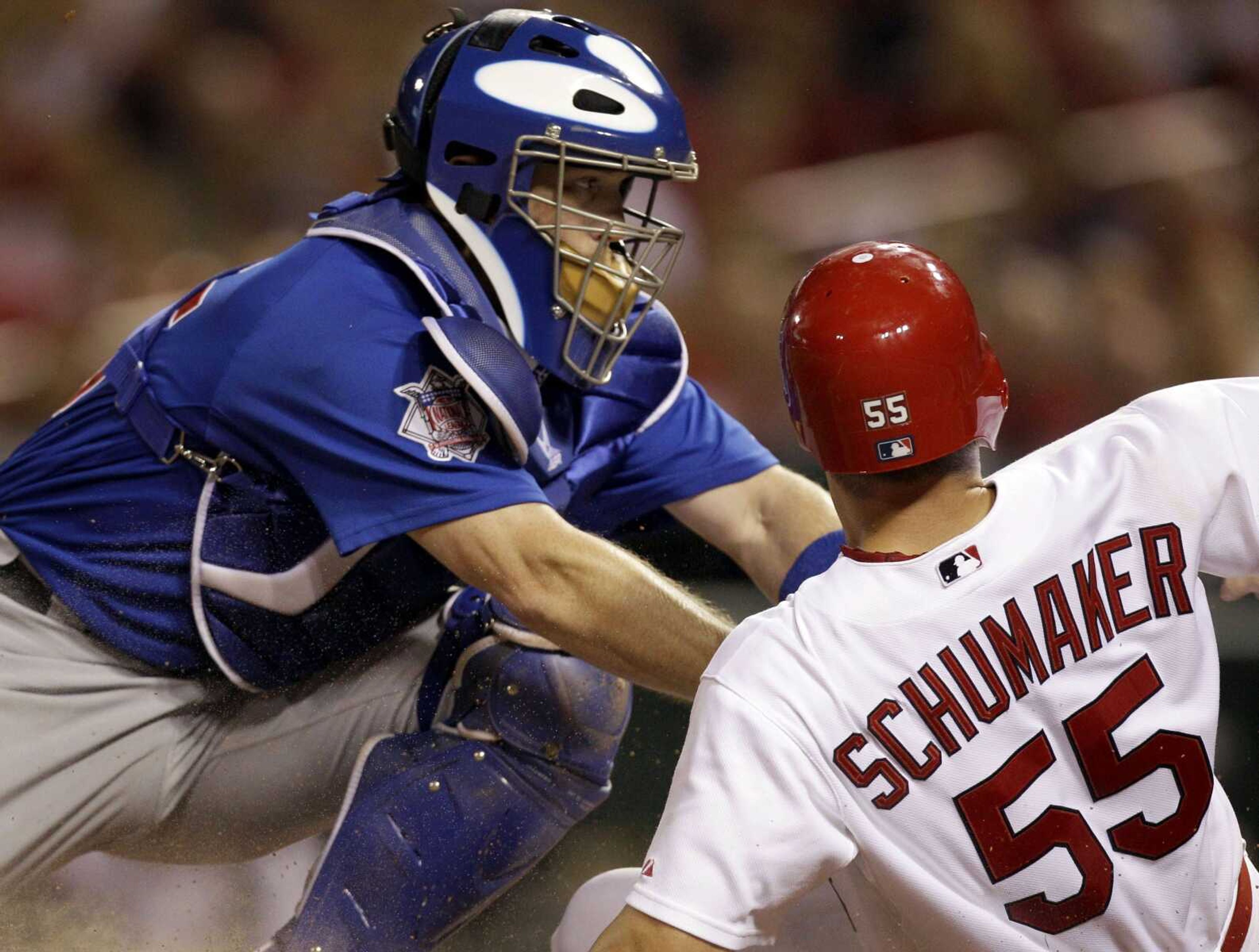 St. Louis Cardinals' Skip Schumaker, right, is safe as he slides across home ahead of the tag from Chicago Cubs catcher Koyie Hill on a sacrifice fly by Colby Rasmus during the third inning of a baseball game Wednesday, Sept. 15, 2010, in St. Louis. (AP Photo/Jeff Roberson)