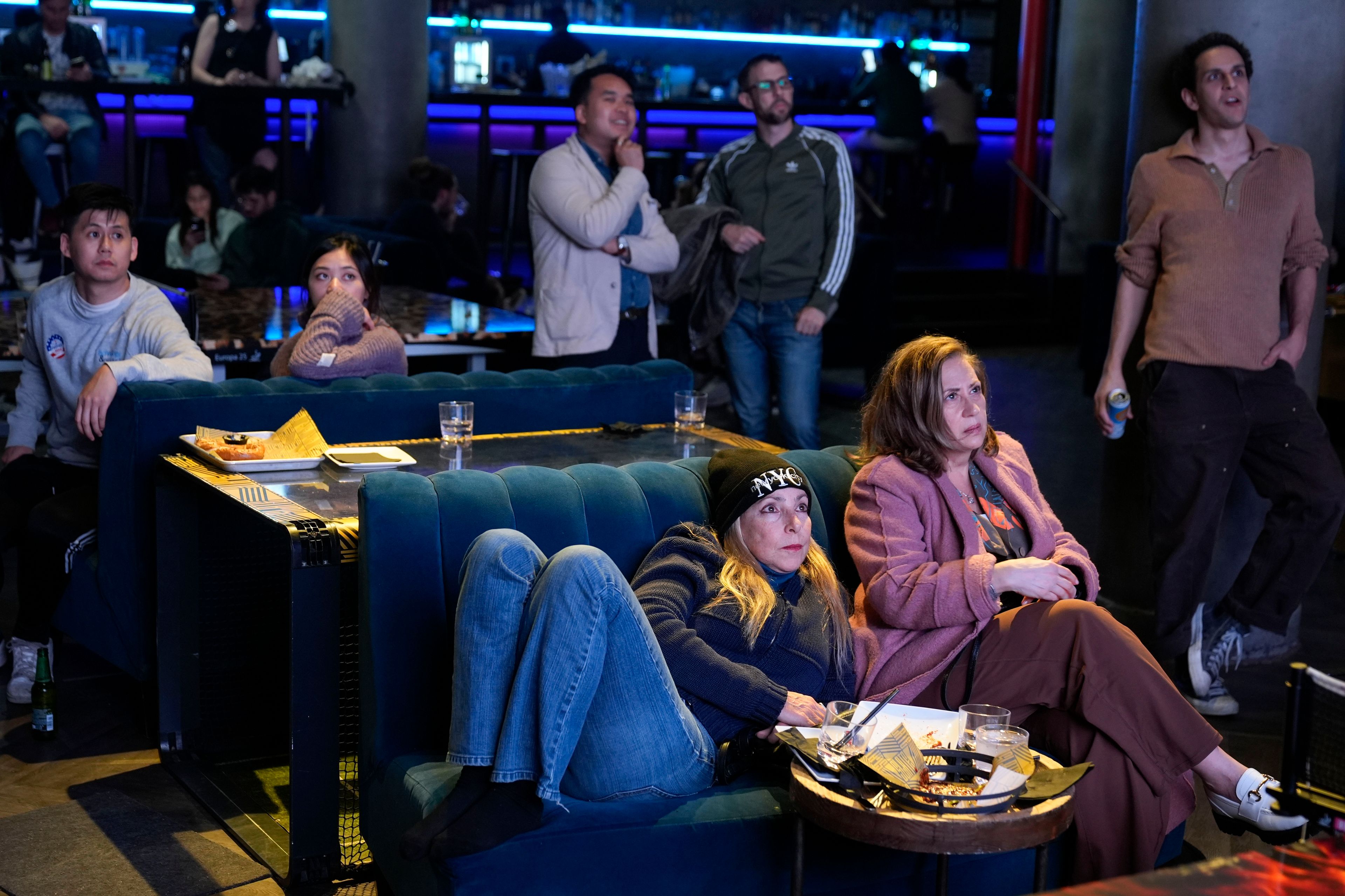 People including Nancy Potter, front left, and Ilene Feinman, front right, watch election returns at a bar in New York, Tuesday, Nov. 5, 2024. (AP Photo/Seth Wenig)