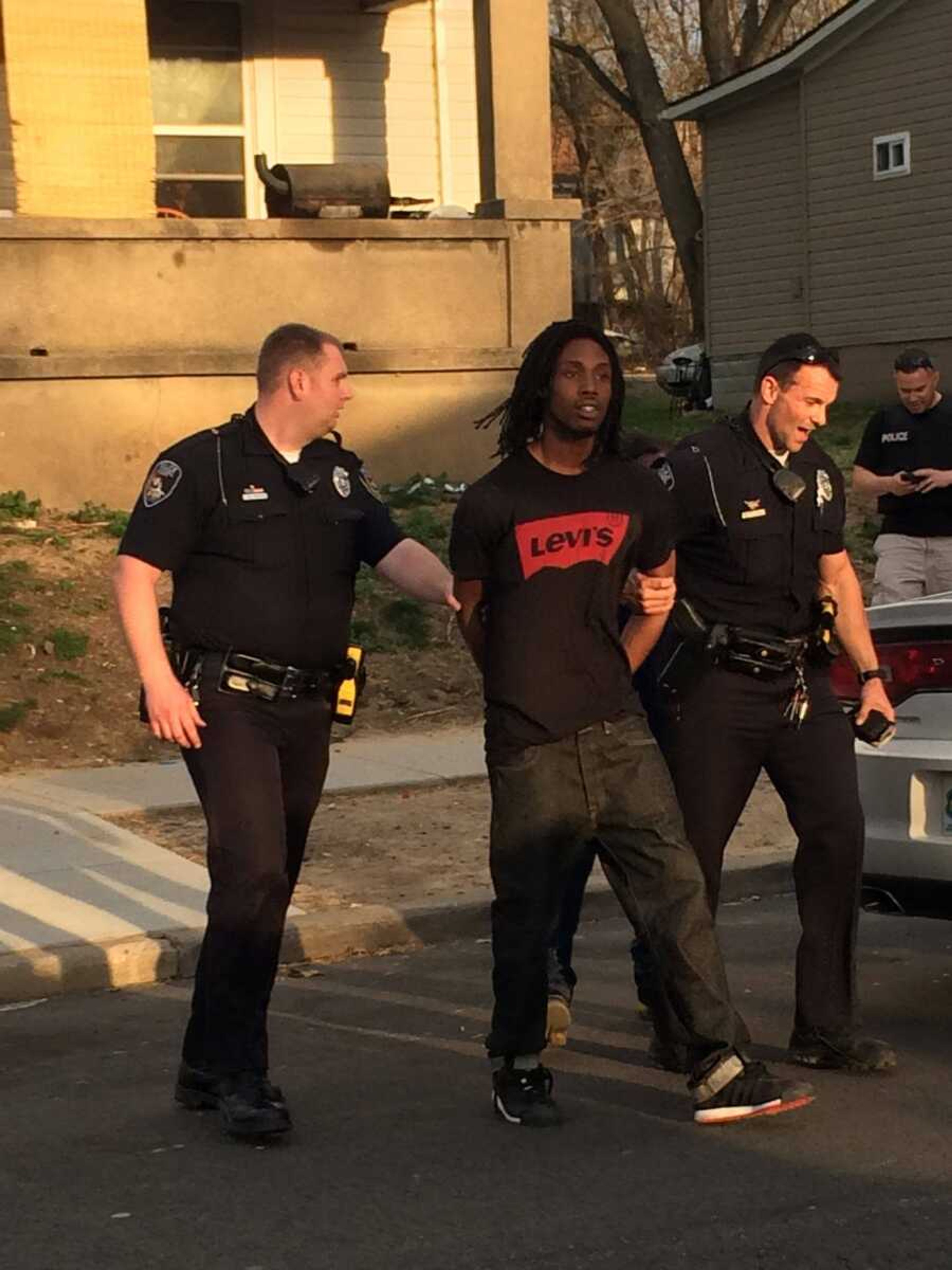 Police escort the suspect out of a house at 420 S. Benton St. in Cape Girardeau on Thursday evening. (Emily Priddy)