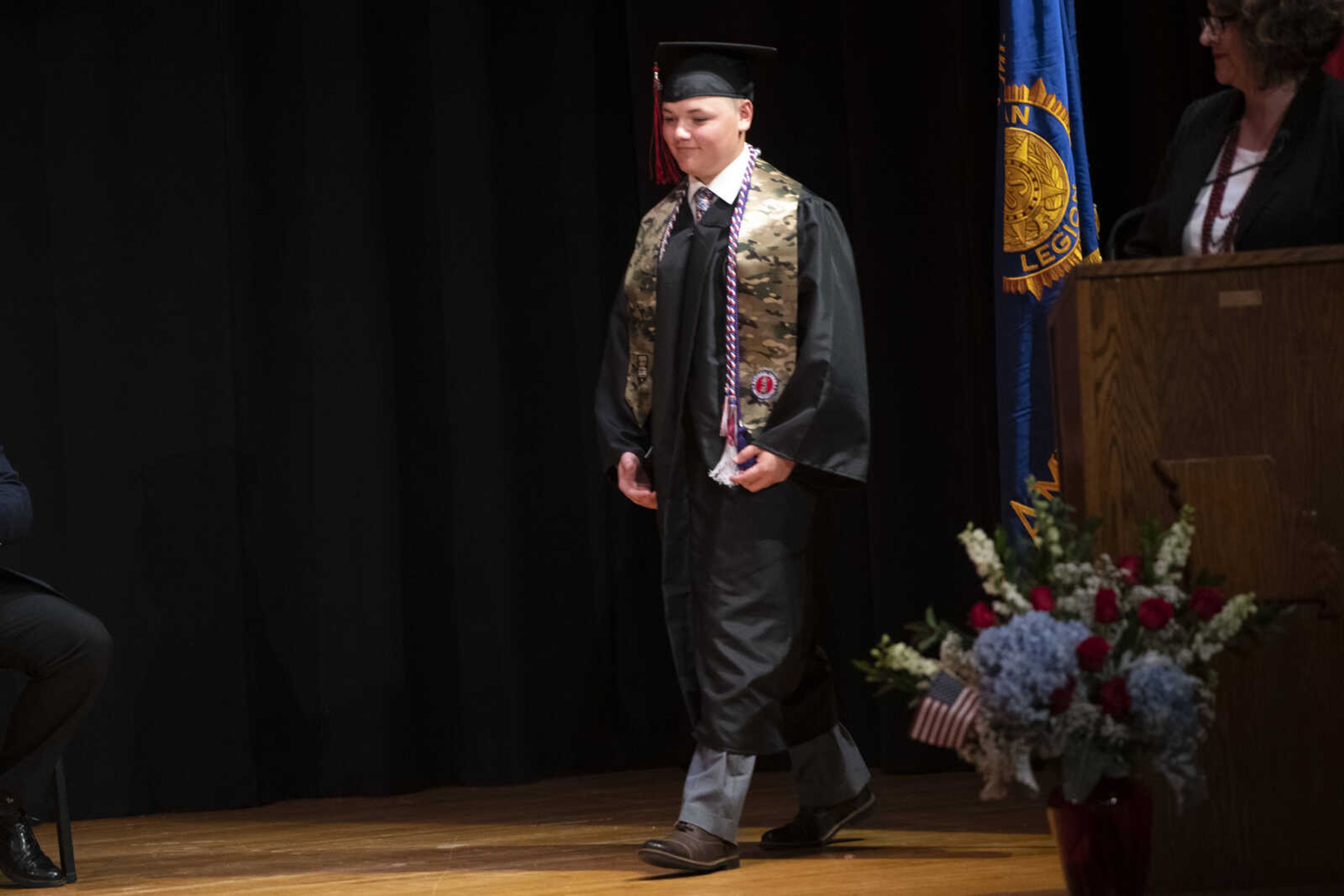 Jackson High School graduate Caleb Scott Anderson walks across the stage during an in-person military graduation ceremony Friday, May 22, 2020, at Jackson High School.