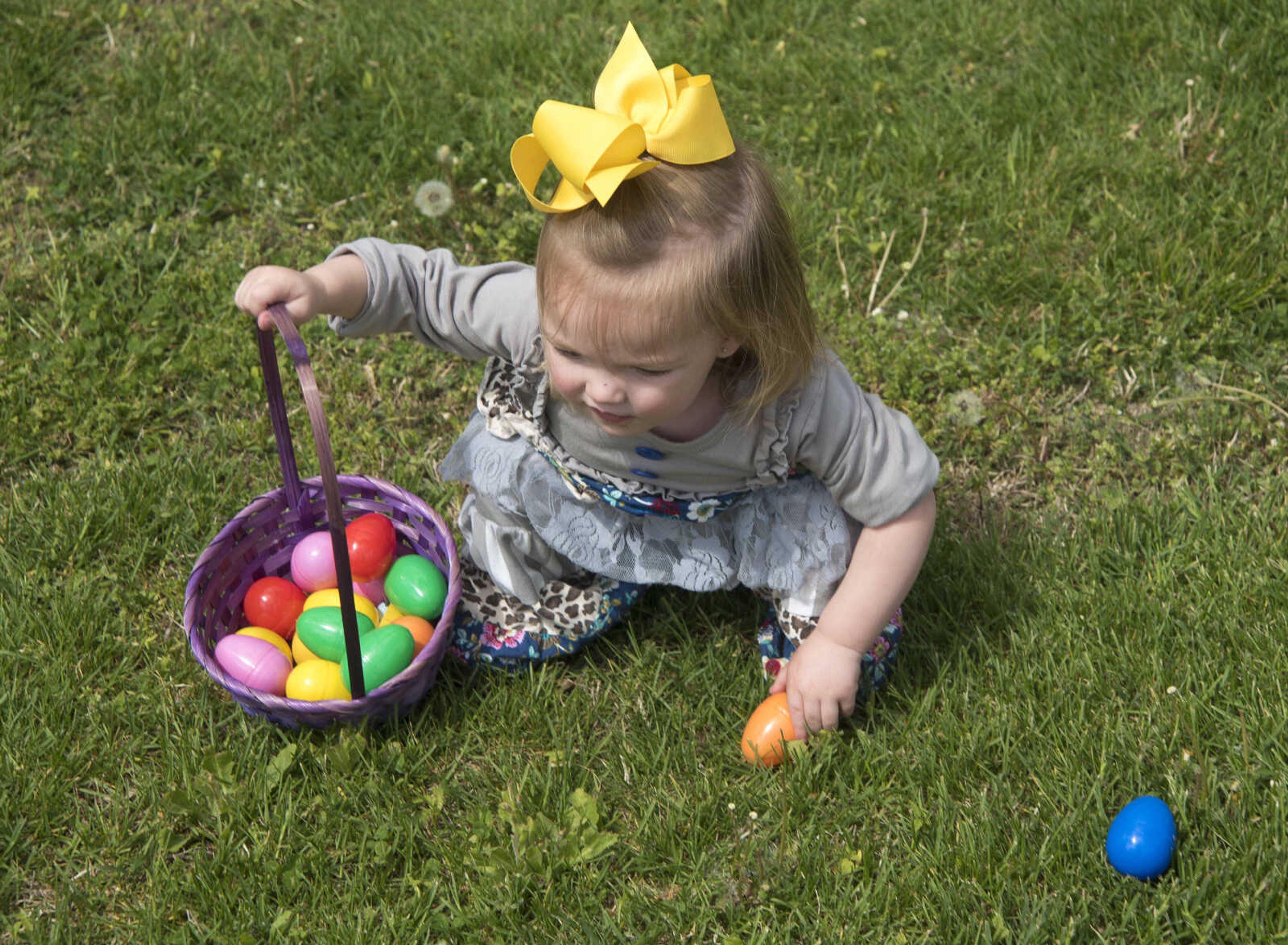 Adaline Boasiney, 1, picks up an Easter egg during the Safari Egg Hunt Saturday, April 15, 2017 at Lazy L Safari Park in Cape Girardeau.