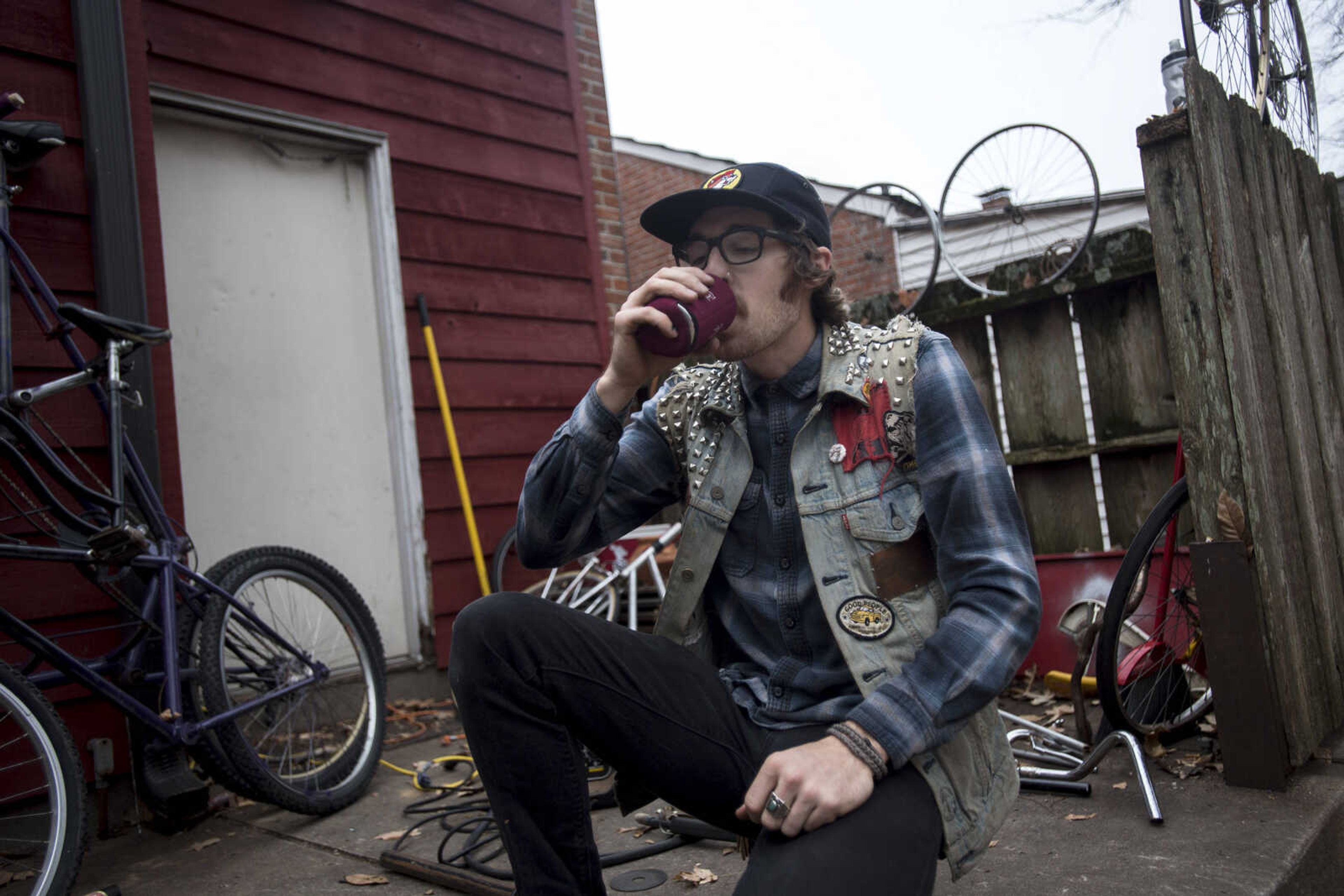 "You can't start building a tall bike without a beer. It's part of the tradition of bunch of dirty punk kids." Parker Bond said while he takes a sip from his beer before working on a new tall bike at his home Thursday, Dec. 21, 2017 in Cape Girardeau.