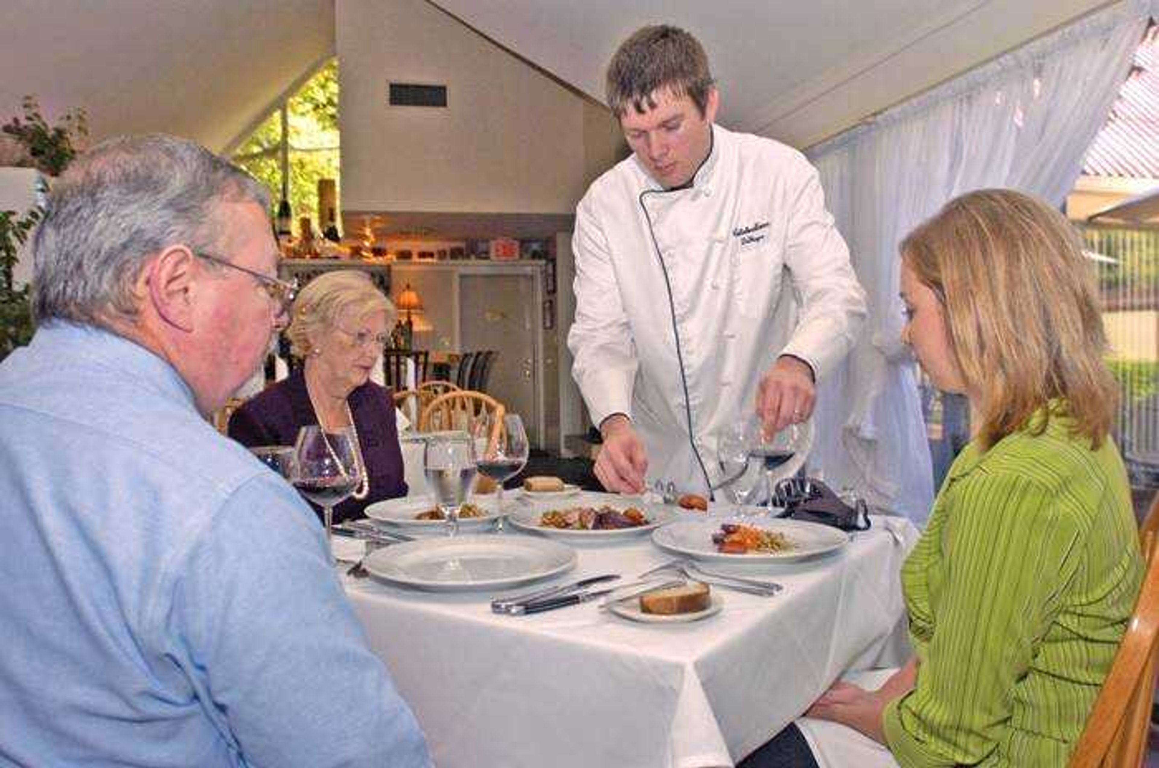 Chef DeWayne Schaaf served his pork tenderloin dish for the AgriMissouri Program contest judges, from left, Buz Sutherland, Frances Hitt and Sarah Gehring, at Celebrations Restaurant in this file photo. (Fred Lynch)