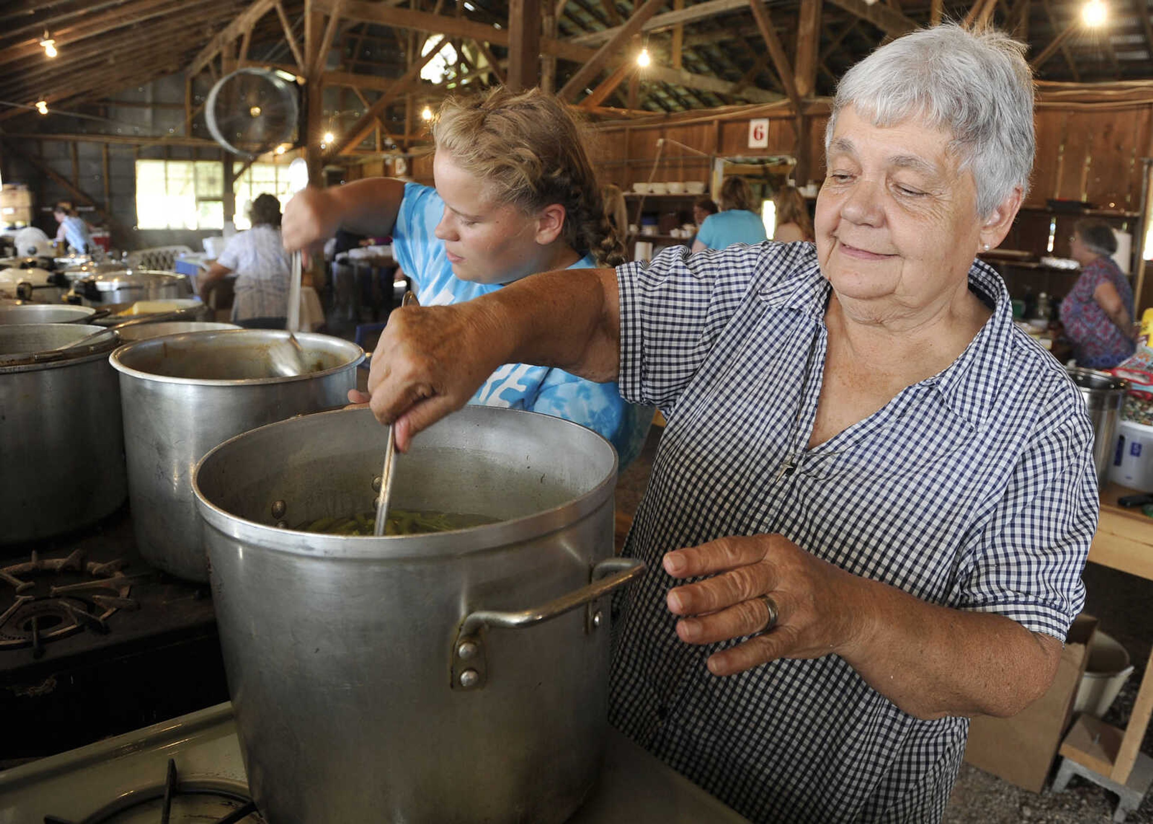 FRED LYNCH ~ flynch@semissourian.com
Donna Elfrink and her granddaughter, Madeline Elfrink, stir green beans on Saturday, July 29, 2017 at the St. John's Church Picnic in Leopold, Missouri.