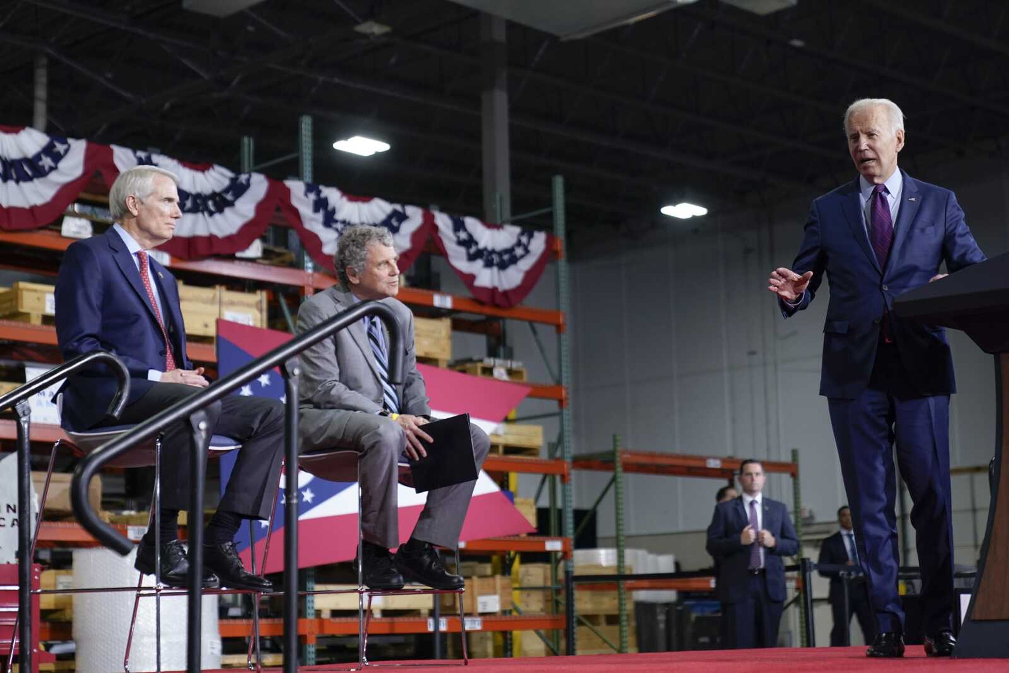 President Joe Biden speaks at United Performance Metals in Hamilton, Ohio, Friday, May 6, 2022. Sen. Rob Portman, R-Ohio, left, and Sen. Sherrod Brown, D-Ohio, second from left, listen. (AP Photo/Andrew Harnik)