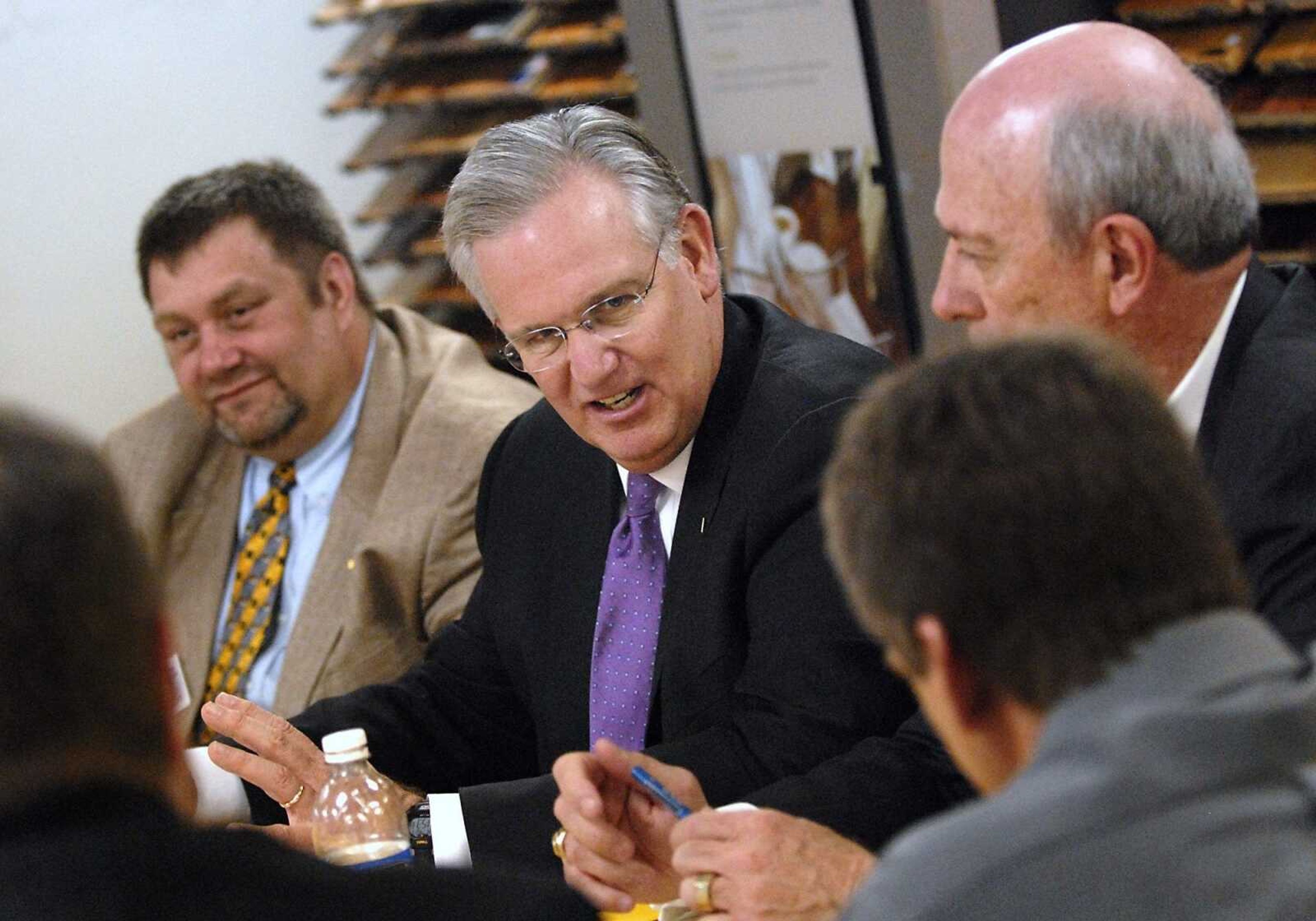 Gov. Jay Nixon, joined by David Kerr, right, director of the Missouri Department of Economic Development, and Richard Proffer, of the Missouri Small Business and Technology Development Center, left,  speak with business owners during a roundtable discussion at Main Street Flooring and Interiors in Jackson on Thursday, April 7, 2011. (Kristin Eberts)