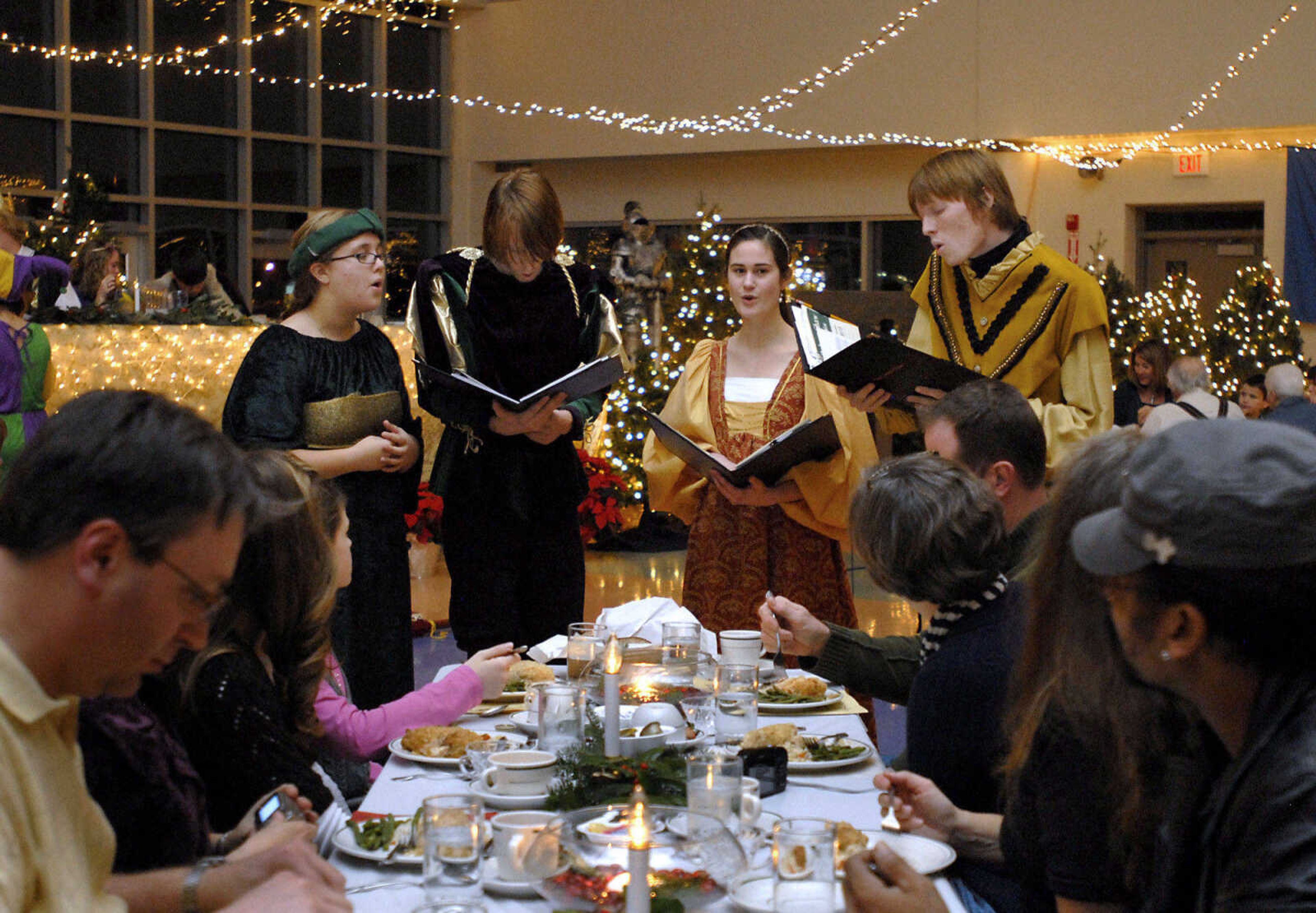 KRISTIN EBERTS ~ keberts@semissourian.com

From left, Leandra Decatoria, Chris Marsyla, Rachel Diamond and Taylor Marsyla serenade a table of guests during the Central High School Choral Department's "Ye Olde Yuletide Madrigal Feaste," on Friday, Dec. 10, 2010, in Cape Girardeau. Students provided singing, food and entertainment as they transported guests back to Christmas in Renaissance England.