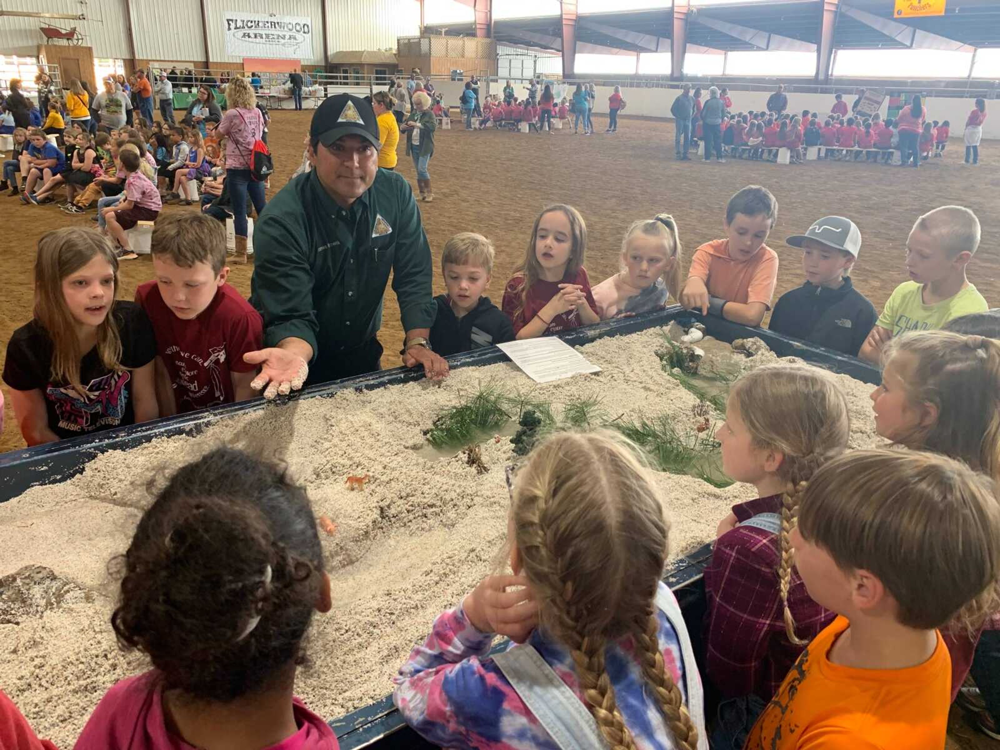 James Borowiak of the Missouri Department of Conservation teaches Jackson students about soil erosion using an interactive display. Erosion is caused by rain moving the soil from one place to another.