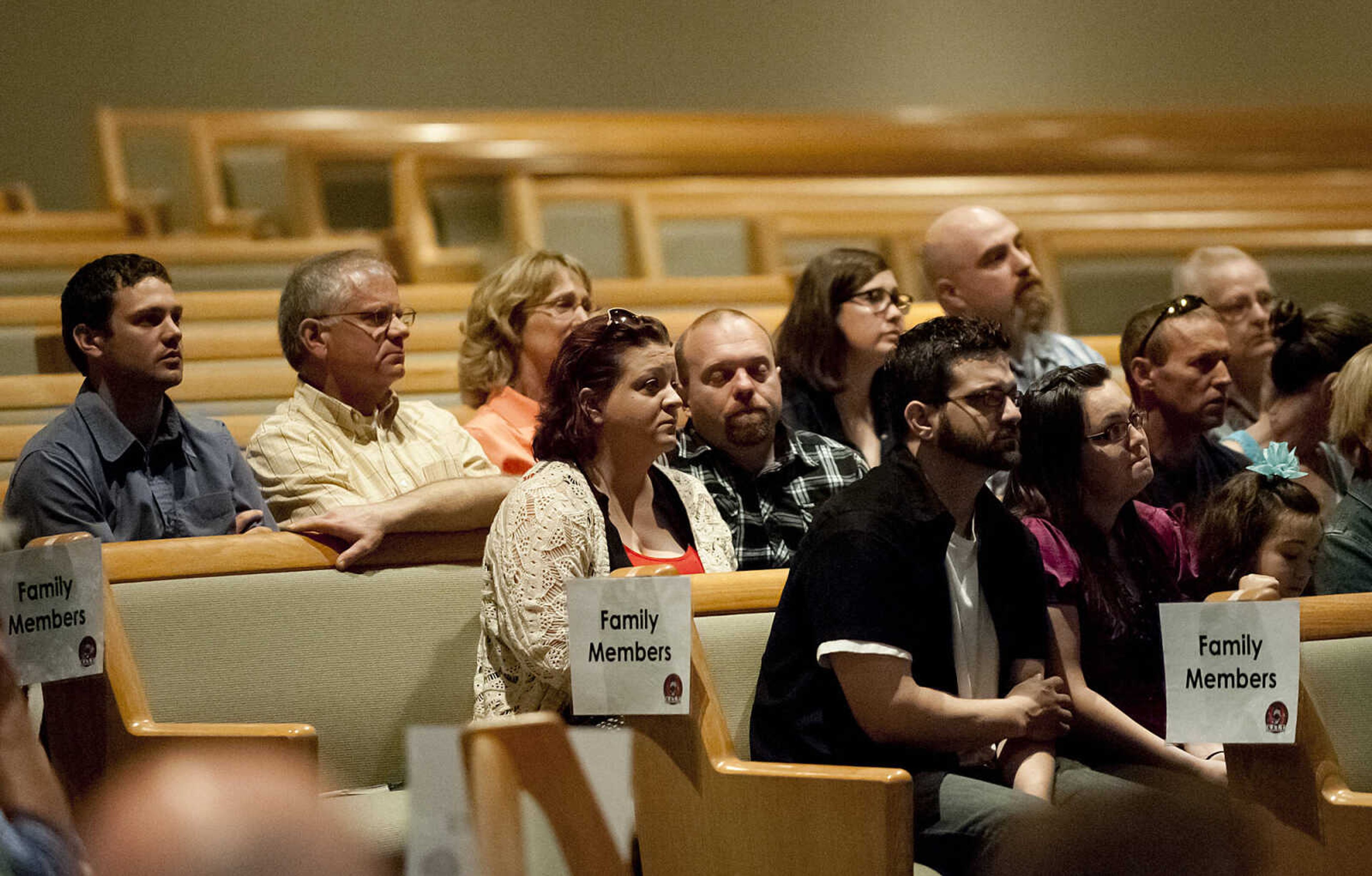 Family members listen as Chaplain Father John Harth reads the names of the 48 Southeast Missouri law enforcement officers that have died in the line of duty since 1875 during the Senior and Lawmen Together Law Enforcement Memorial Friday, May 9, at the Cape Bible Chapel.