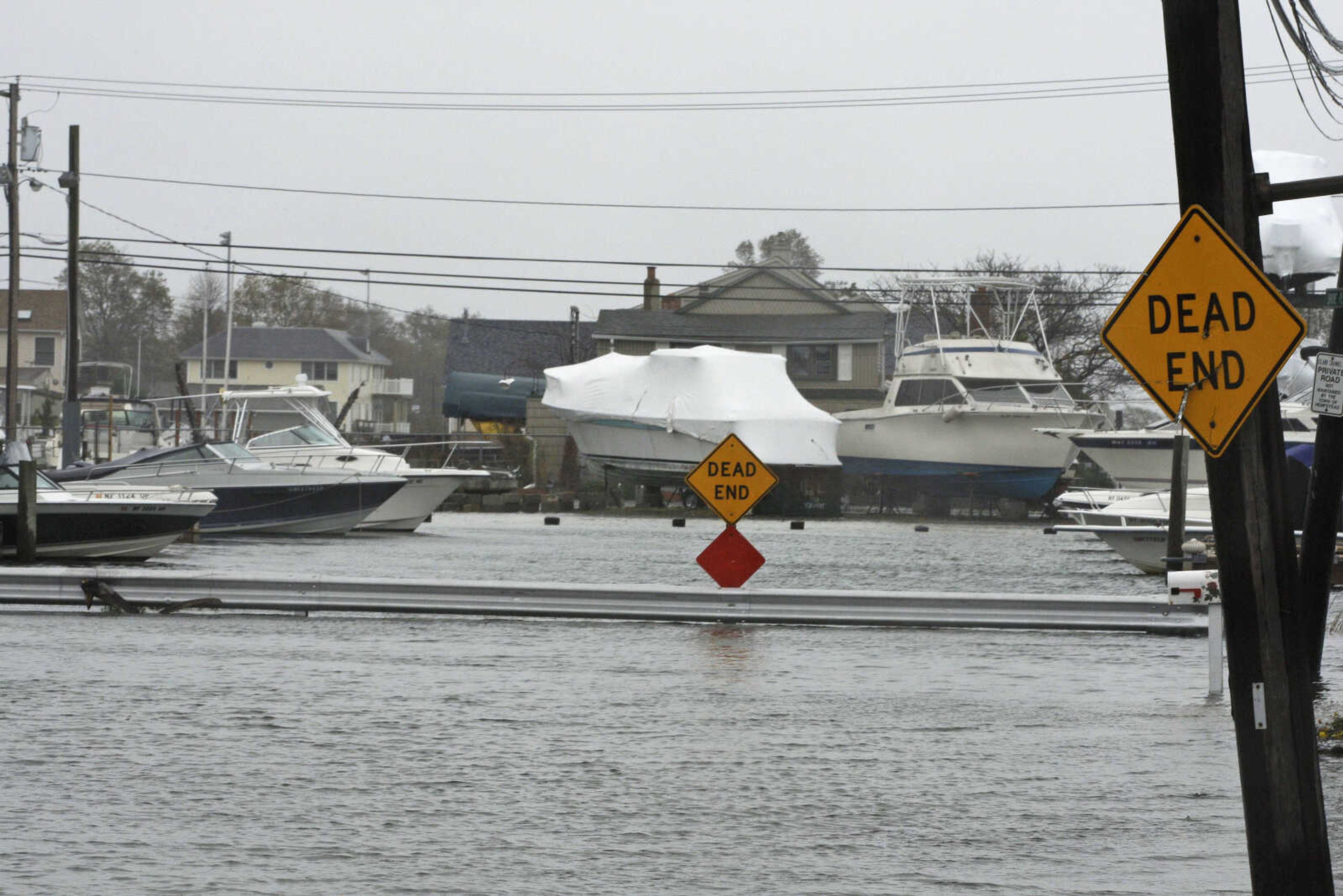 Water from Hurricane Sandy floods streets Monday, Oct. 29, 2012, in Seaford, N.Y. Hurricane Sandy continued on its path Monday, as the storm forced the shutdown of mass transit, schools and financial markets, sending coastal residents fleeing, and threatening a dangerous mix of high winds and soaking rain.Ę (AP Photo/Gerry Broome)