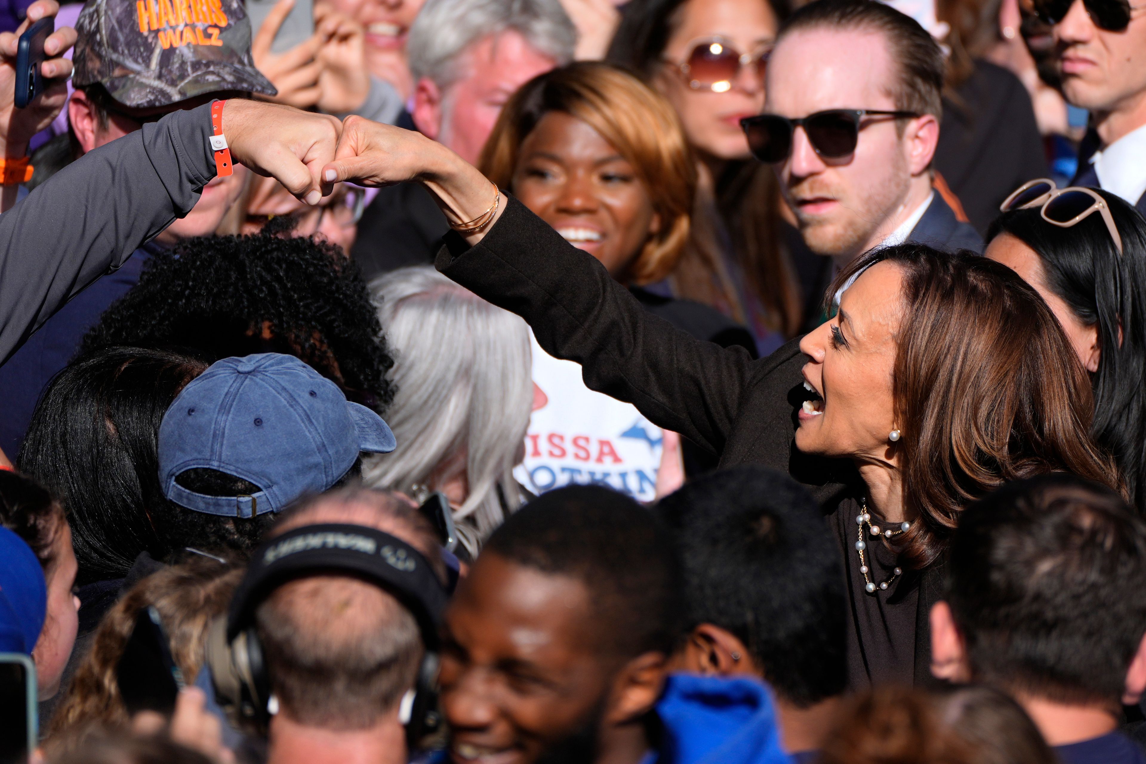 Democratic presidential nominee Vice President Kamala Harris fist-bumps a supporters after speaking at a campaign rally in Riverside Park, Friday, Oct. 18, 2024, in Grand Rapids, Mich. (AP Photo/Paul Sancya)