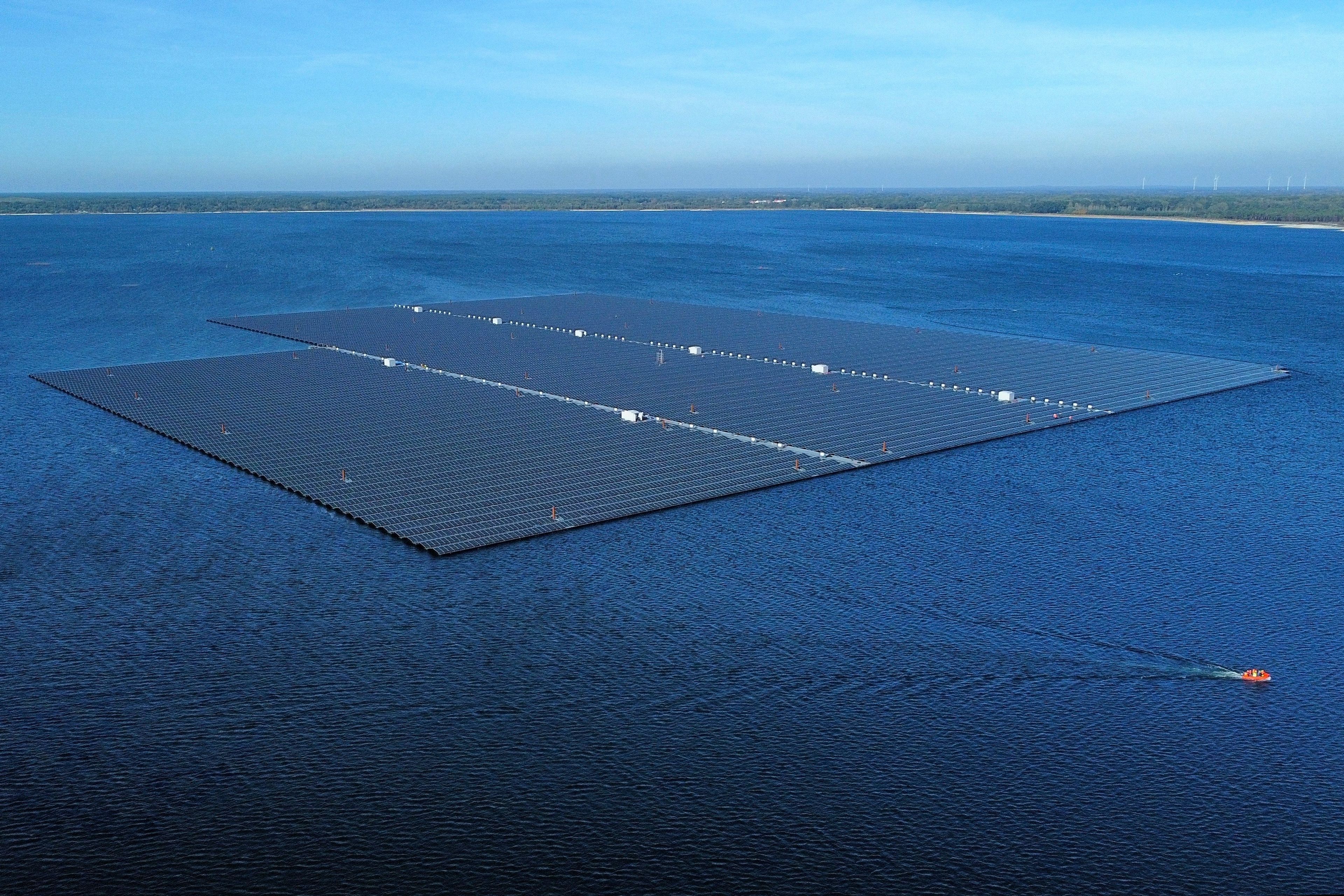 Floating solar panels operate on the Cottbuser Ostsee lake near Cottbus, Germany, Wednesday, Oct. 16, 2024. (AP Photo/Matthias Schrader)