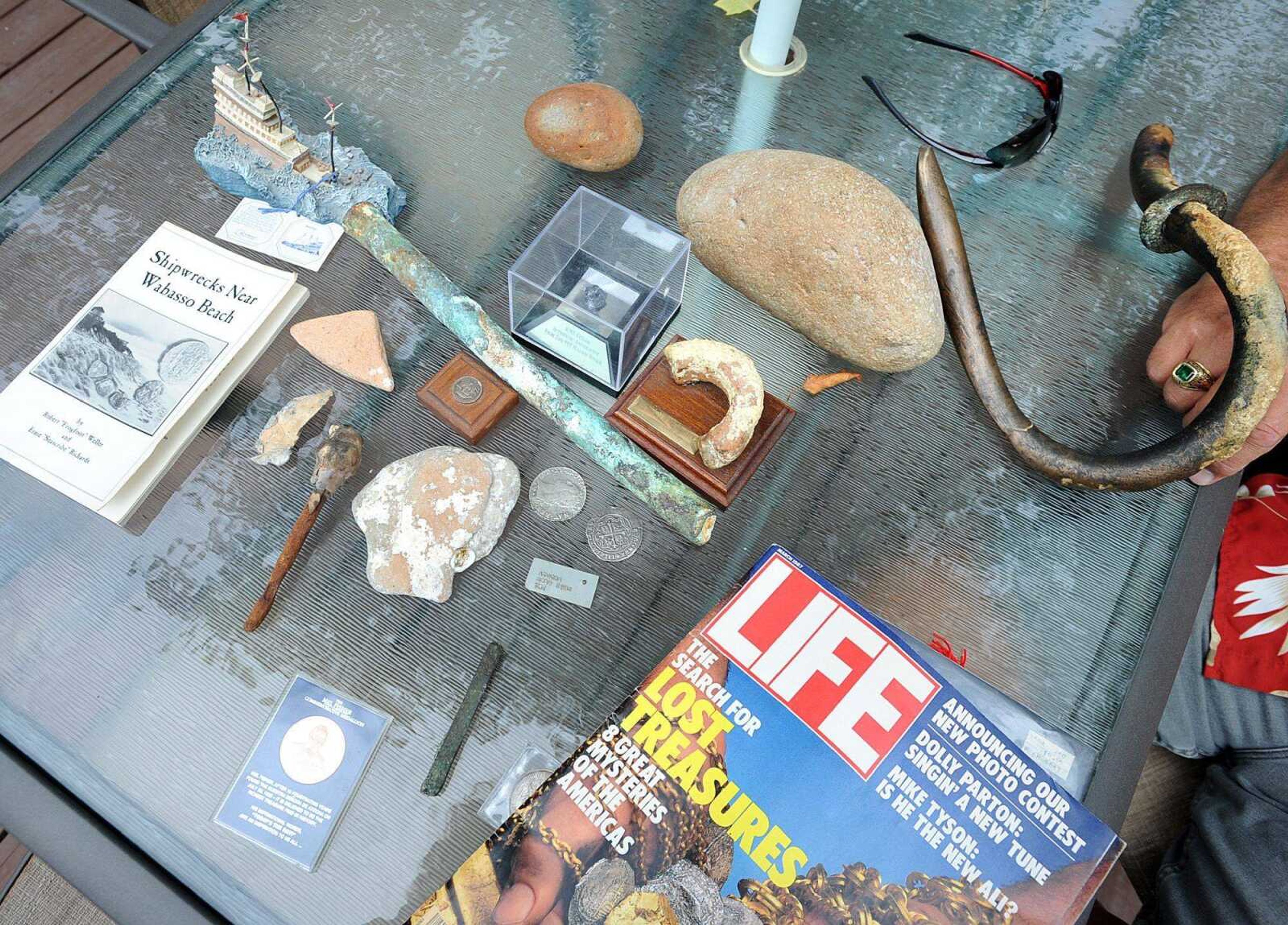 Treasures and research books Randy Barnhouse has collected over the years are displayed on his patio table Aug. 27.
(Laura Simon)