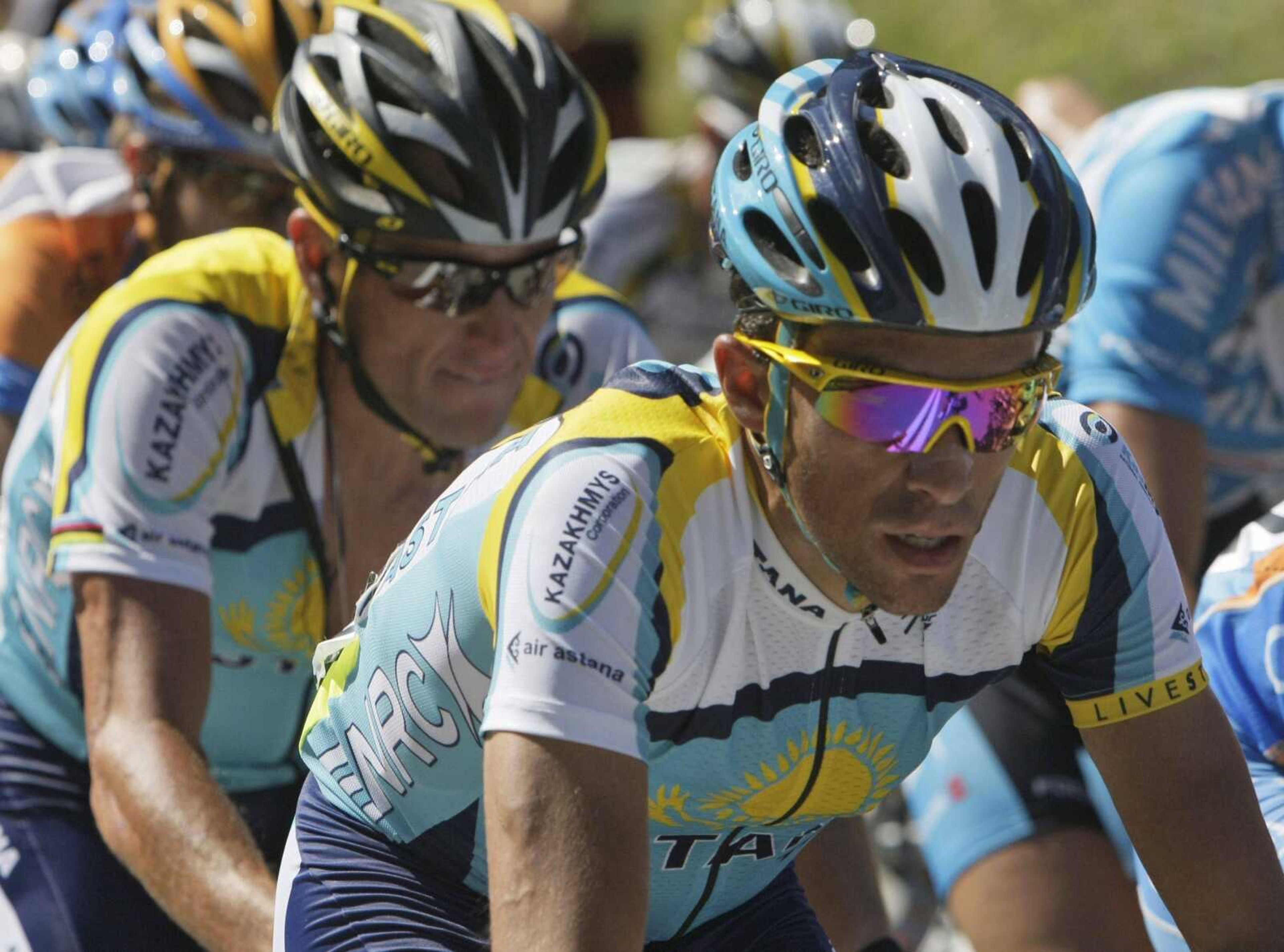 New overall leader Alberto Contador, right, followed by Lance Armstrong, left, rides Sunday during the 15th stage of the Tour de France cycling race Sunday. (Bas Czerwinski ~ Associated Press)