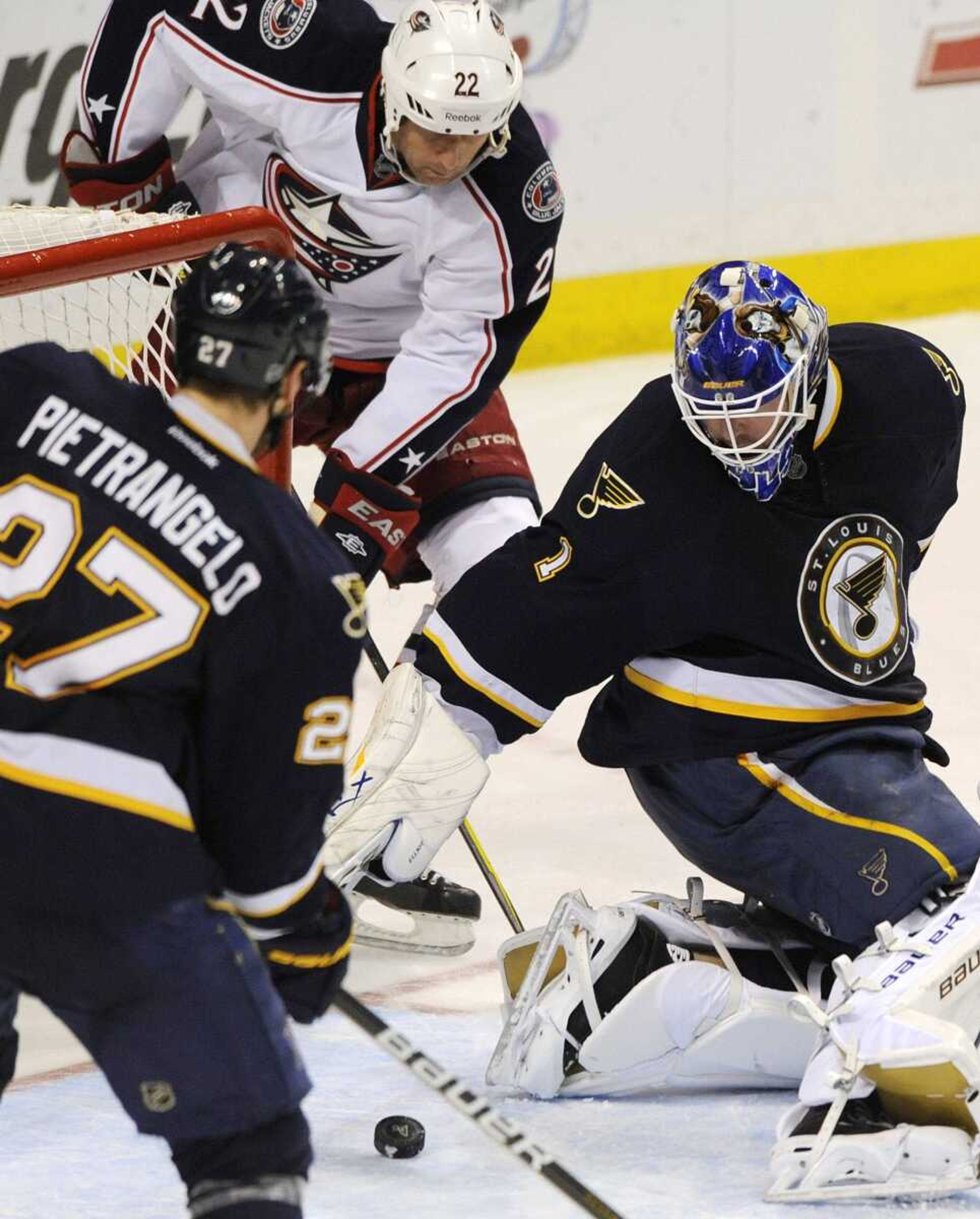 Blues goalie Brian Elliott blocks a shot by Columbus' Vinny Prospal, right, as the Blues' Alex Pietrangelo defends during the second period Saturday in St. Louis. The Blues won 4-1 to improve to 29-7-4 at home this season. (BILL BOYCE ~ Associated Press)