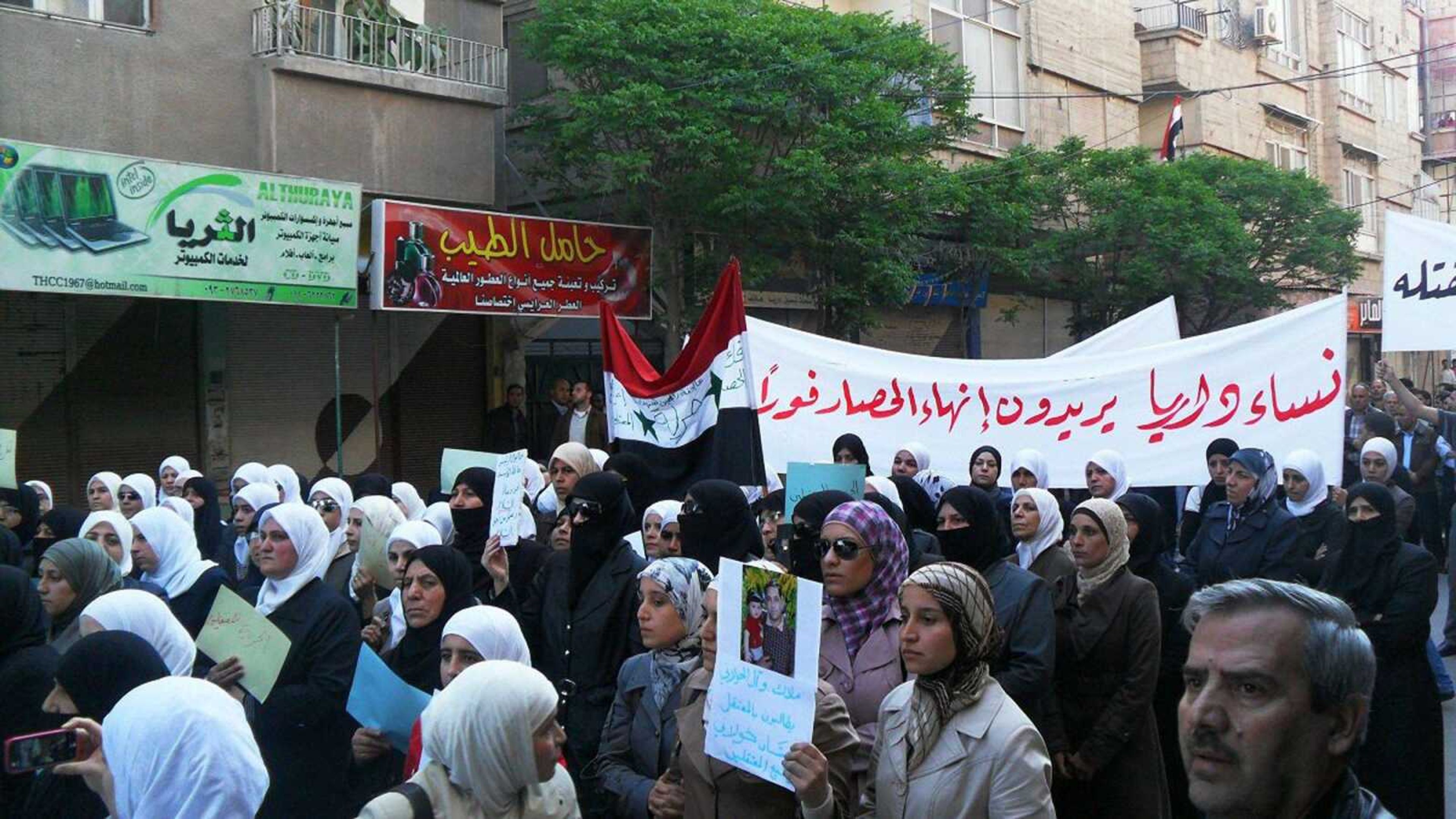 Associated Press (In this mobile phone image acquired by the Associated Press, Syrian women carry a banner in Arabic that reads "The women of Daraya want an end to the siege," as they protest Monday in Daraya, Syria. In an escalation of Syria's crackdown on dissent, thousands of soldiers backed by tanks poured into the southern city of Daraa on the Jordanian border, the city where the uprising began, opening fire indiscriminately on civilians and killing at least 11 people, witnesses said.)