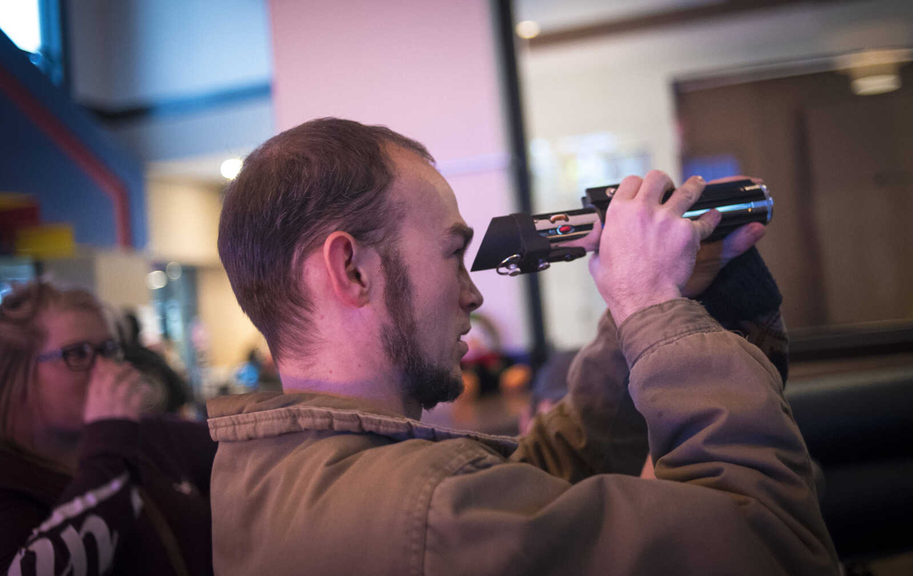 Trey Kerley with the Southern Illinois Jedi Order looks down the lightsaber before the showing of Star Wars: The Last Jedi Thursday, Dec. 14, 2017 at Cape West Cinema in Cape Girardeau.