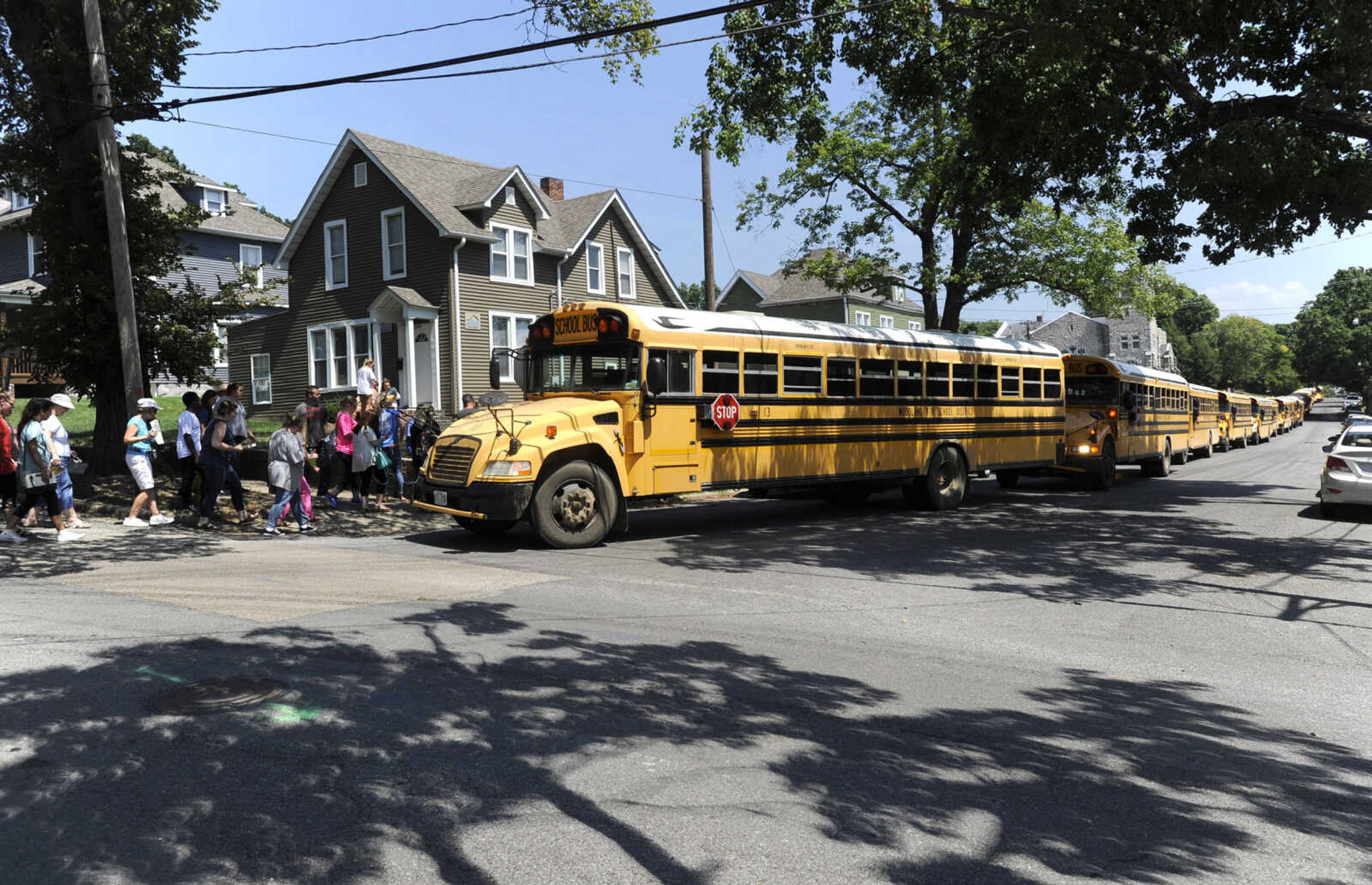 FRED LYNCH ~ flynch@semissourian.com
School buses line up from Pacific Avenue back to Sprigg Street to pick up students after the solar eclipse Monday, Aug. 21, 2017 in Cape Girardeau. Notice the crescent shapes of the eclipse through the tree shadows on the street.