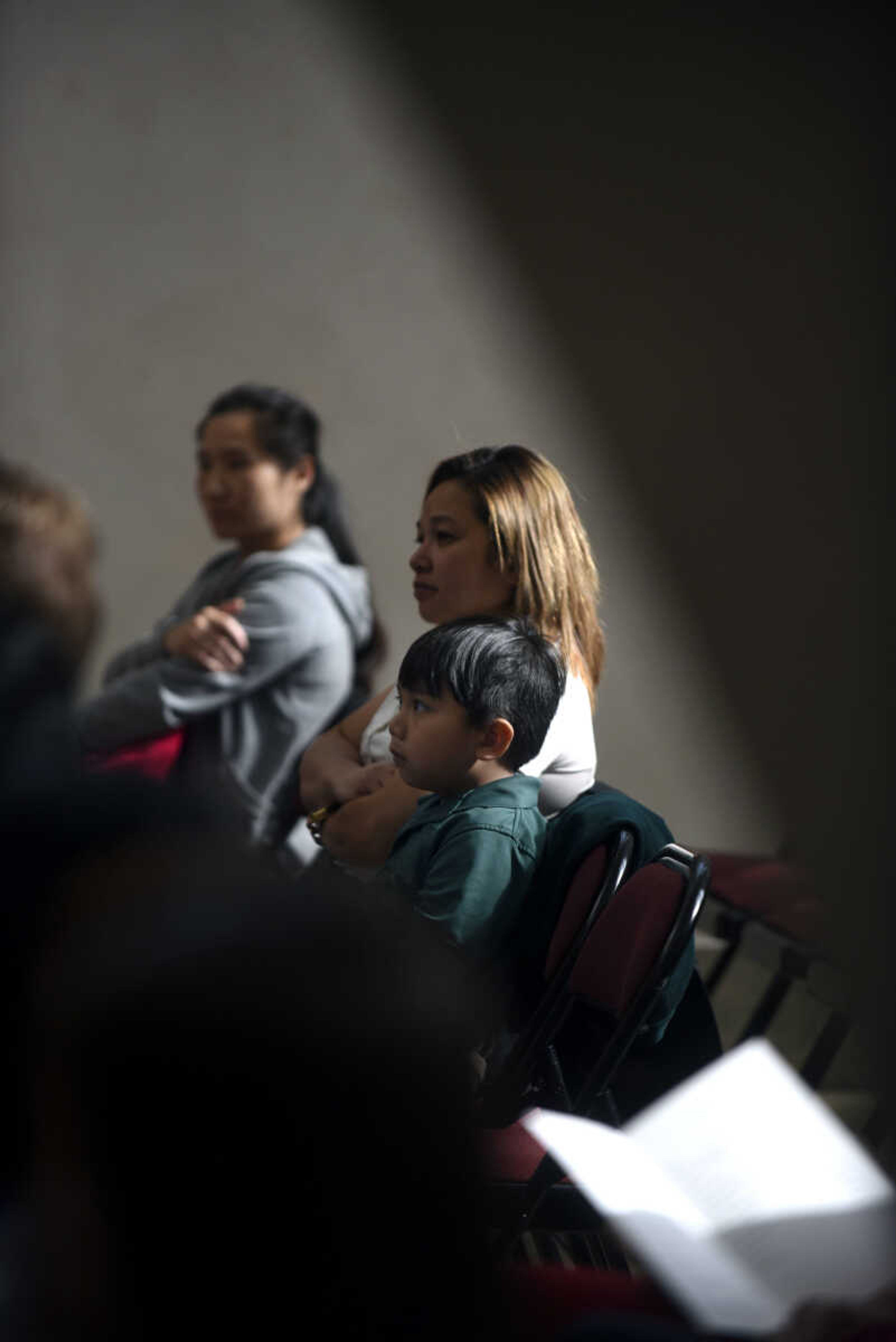 Abigail Magsaysay and her son Geno Magsaysay, 6, sit and listen during the United States District Court Eastern District of Missouri Southeastern Division's naturalization ceremony on Friday, April 6, 2018, at the Rush Hudson Limbaugh, Jr., United States Courthouse in Cape Girardeau.