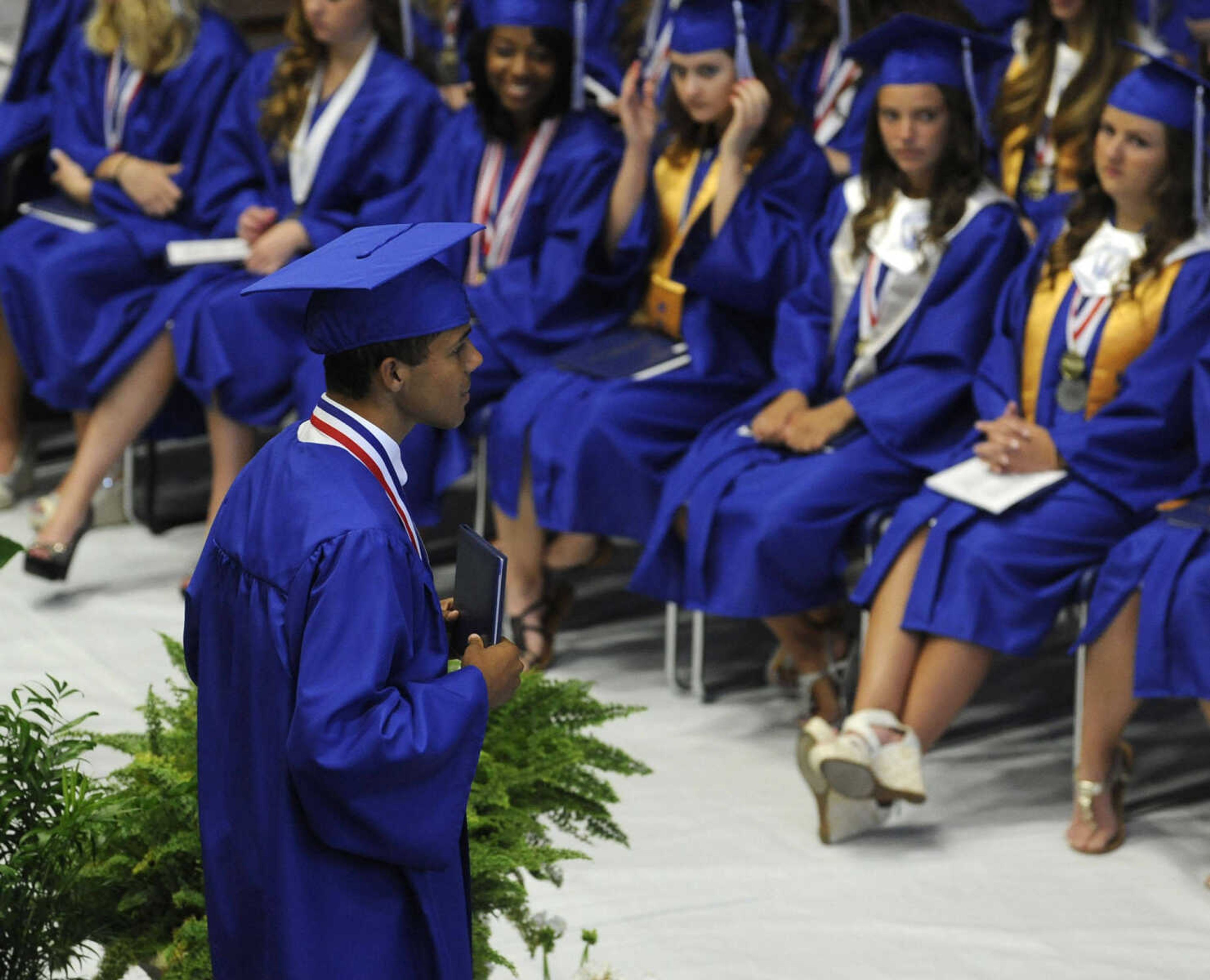 Logan Mainord poses for pictures after receiving a diploma at the Notre Dame Regional High School commencement Sunday, May 18, 2014.