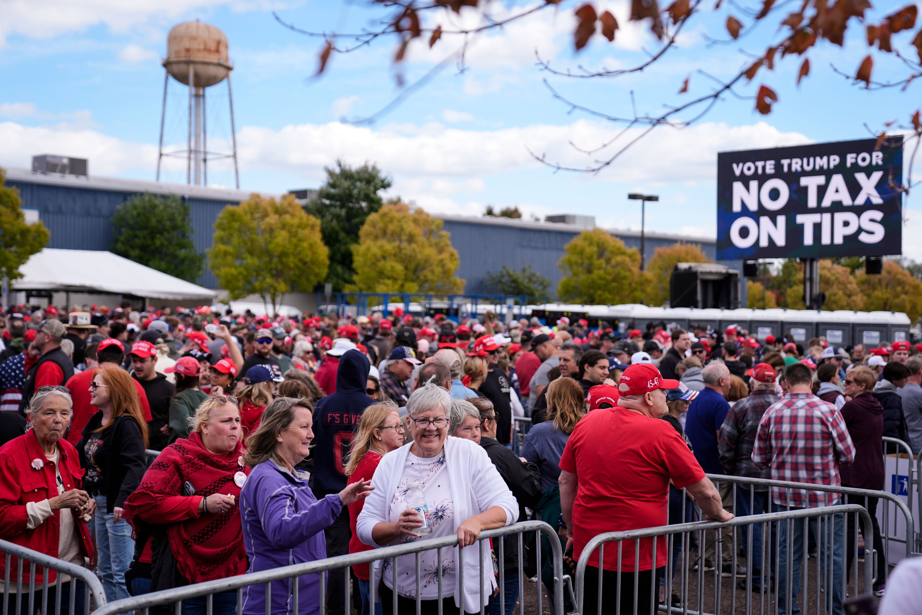 People wait in line to attend a Republican presidential nominee former President Donald Trump campaign town hall, Monday, Oct. 14, 2024, in Oaks, Pa. (AP Photo/Matt Rourke)