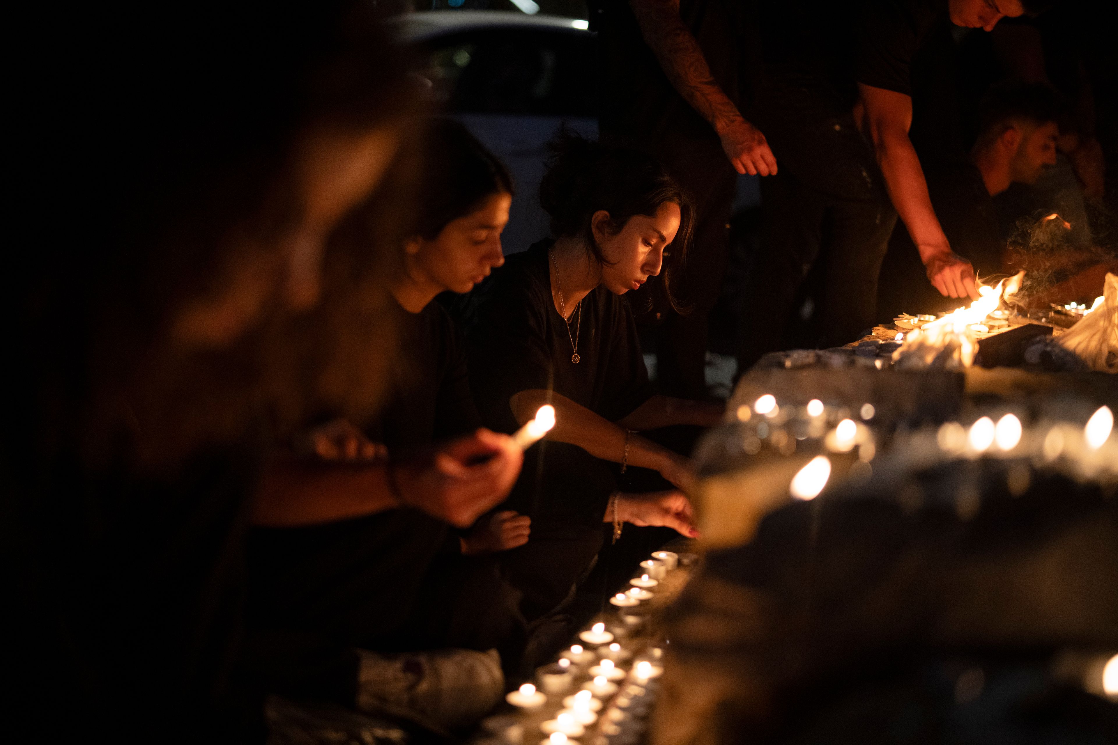 People light candles in memory of the children and teens killed in a rocket strike at a soccer field at the village of Majdal Shams, in the Israeli-annexed Golan Heights, Sunday, July 28, 2024. A rocket strike at a soccer field in the village has killed at least 12 children and teens. It's the deadliest strike on an Israeli target along the country's northern border since the fighting between Israel and the Lebanese militant group Hezbollah began. (AP Photo/Leo Correa)