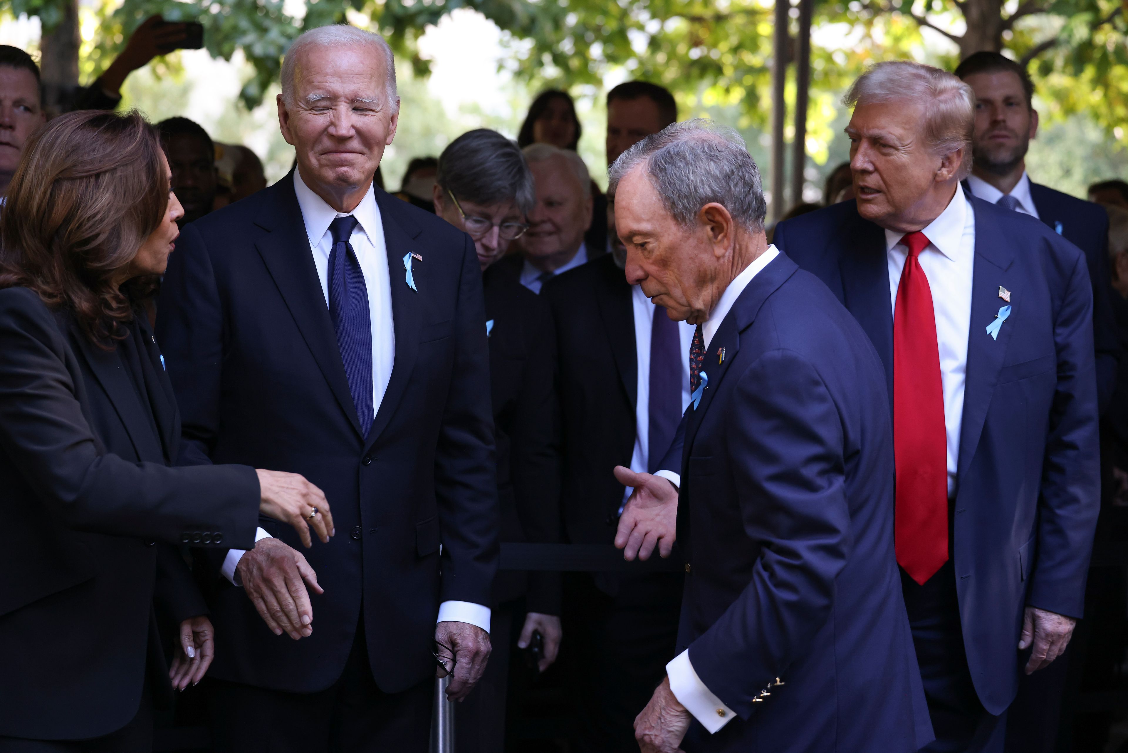 Democratic presidential nominee Vice President Kamala Harris, far left, greets Republican presidential nominee former President Donald Trump, far right, as President Joe Biden and Michael Bloomberg look on upon arriving for the 9/11 Memorial ceremony on the 23rd anniversary of the Sept. 11, 2001 attacks, Wednesday, Sept. 11, 2024, in New York. (AP Photo/Yuki Iwamura)