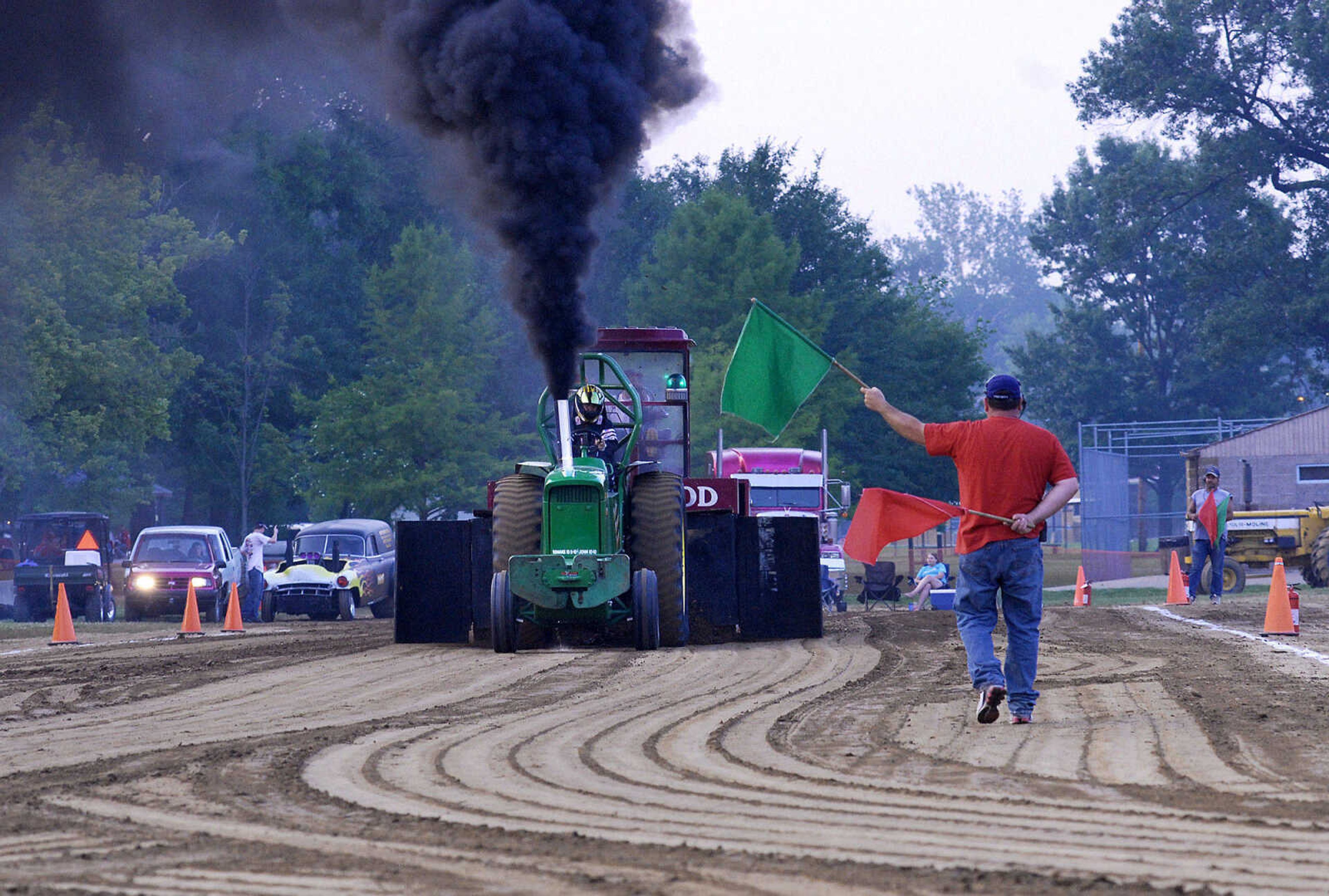 LAURA SIMON~lsimon@semissourian.com
A contestant gets the green flag to start pulling Saturday, May 29, 2010 during the "Pullin' for St. Jude" tractor and truck pull at Arena Park.