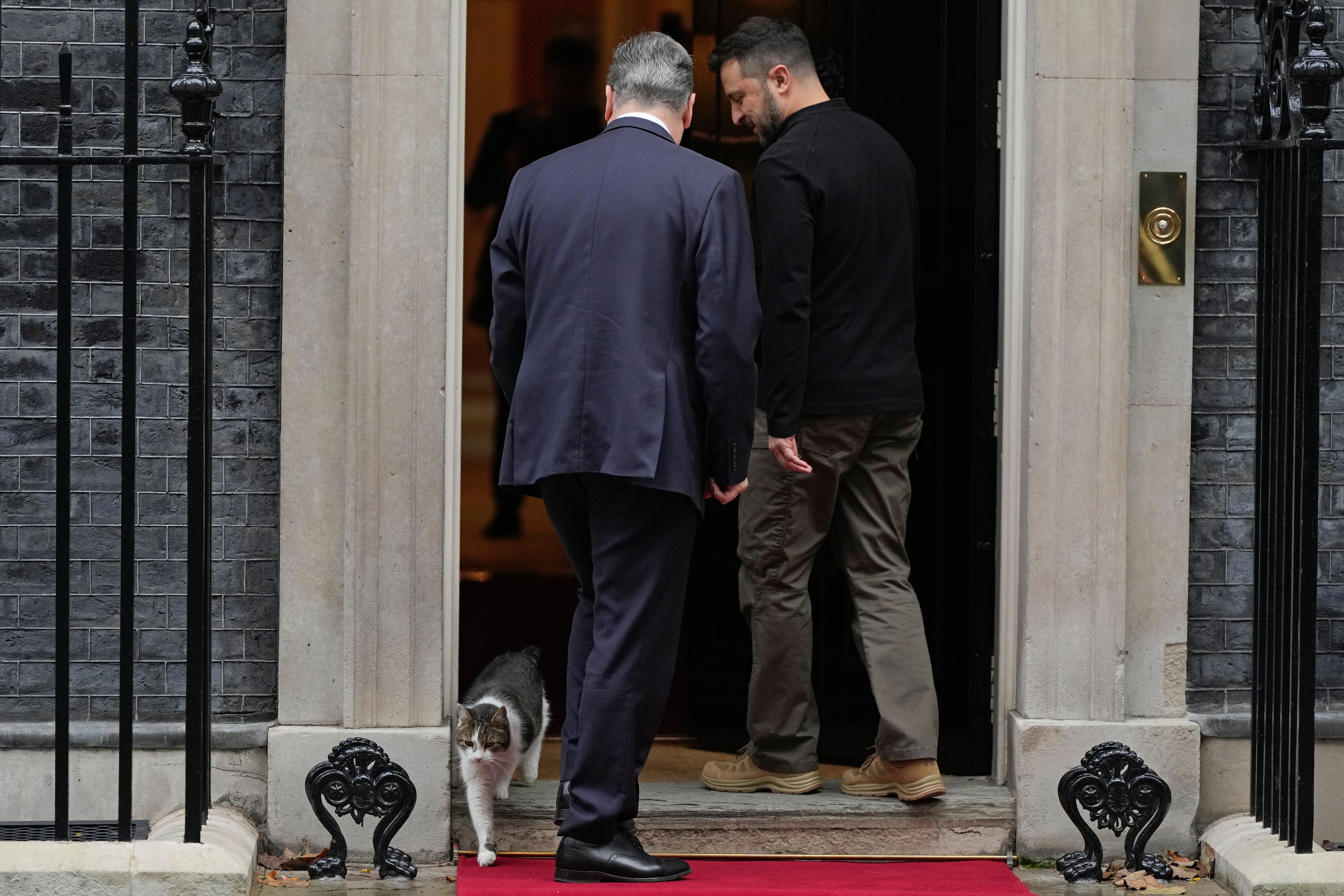 Britain's Prime Minister Keir Starmer welcomes Ukrainian President Volodymyr Zelenskyy to 10 Downing Street as Larry the cat, Chief Mouser to the Cabinet Office, steps out in London, Thursday, Oct. 10, 2024.(AP Photo/Alastair Grant)