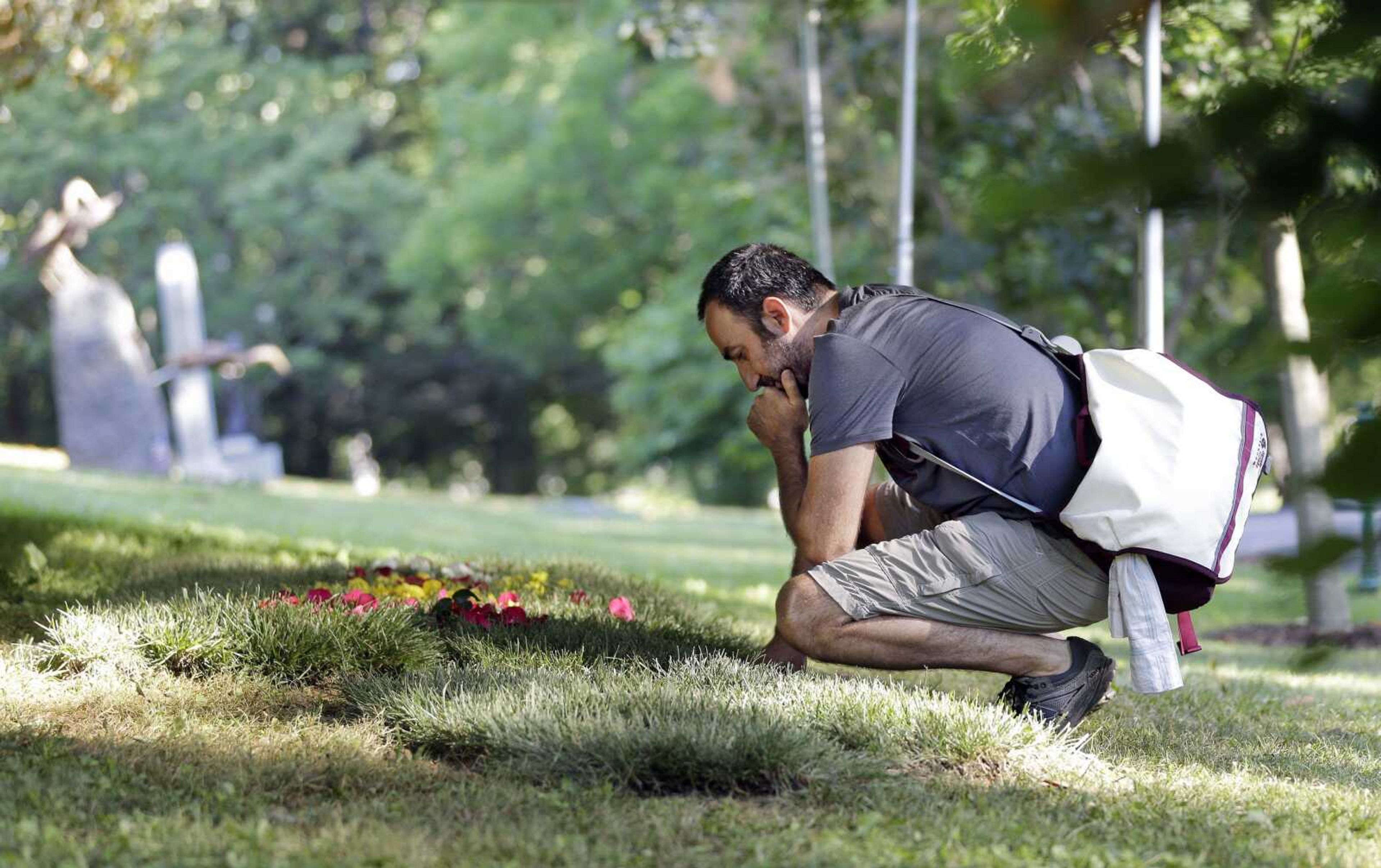 Farzam Farrokhi, an Iranian native now living in New York, on Saturday visits the grave of boxing great Muhammad Ali in Louisville, Kentucky. Cave Hill Cemetery opened to the public Saturday, the day after Ali's burial.