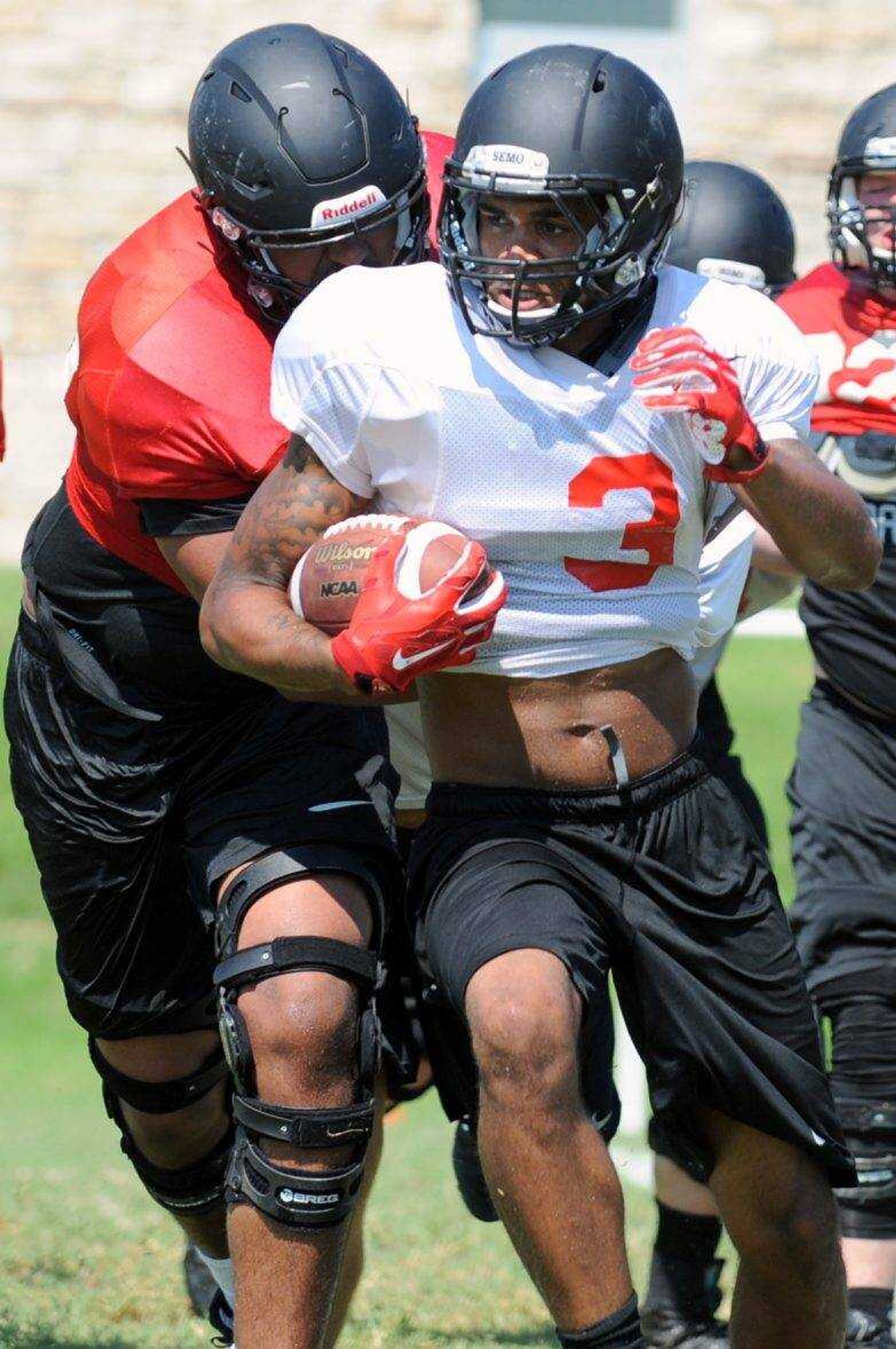 
Southeast Missouri State running back Chase Abbington carries the ball while defensive lineman Ryan Truvillion attempts to bring him down during practice Wednesday, Aug. 10, 2016 at the Rosengarten Athletic Complex.