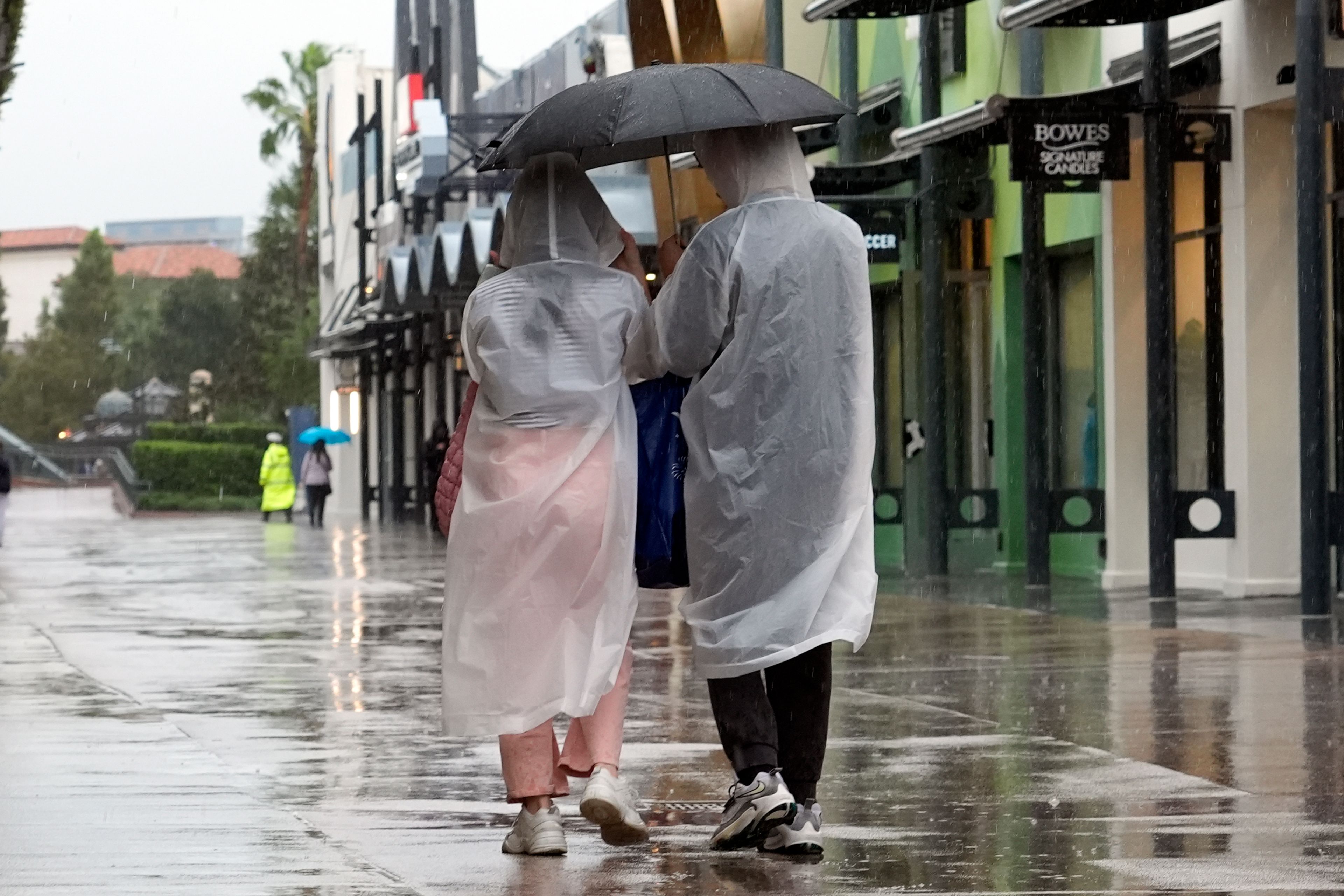 Tourists take in a last minute visit to Disney Springs entertainment complex before the arrival of Hurricane Milton Wednesday, Oct. 9, 2024, in Lake Buena Vista, Fla. (AP Photo/John Raoux)